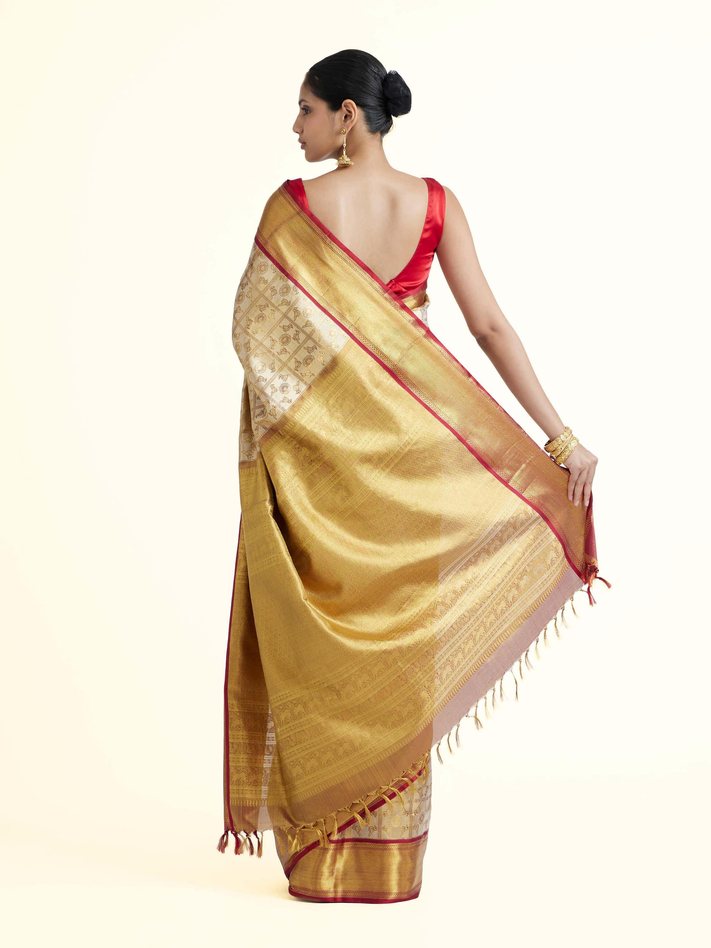 Back view of gold silk Kancheepuram saree displaying ornate pallu design