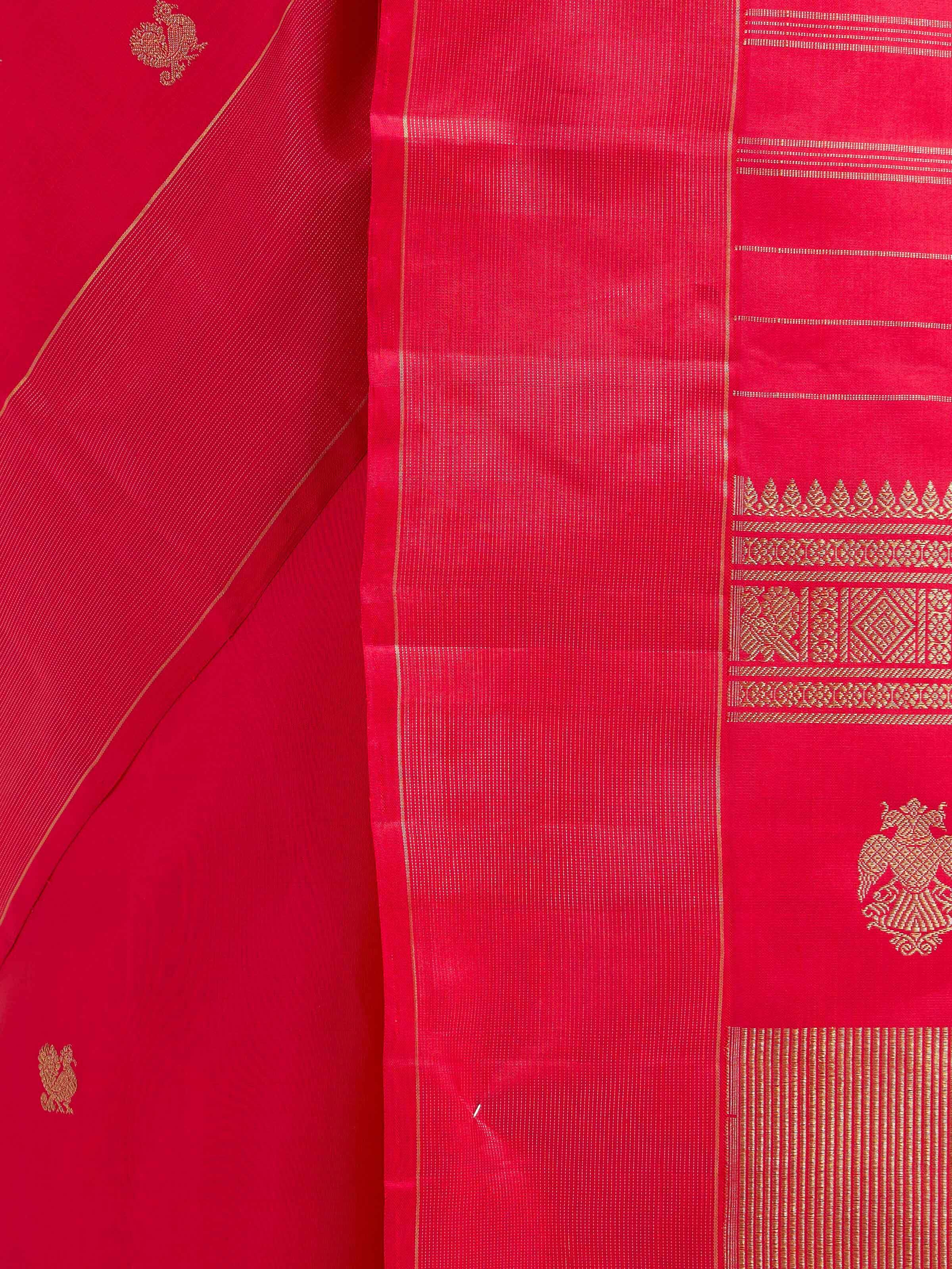 Detail view of red silk Kancheepuram saree showing silk texture and zari craftsmanship