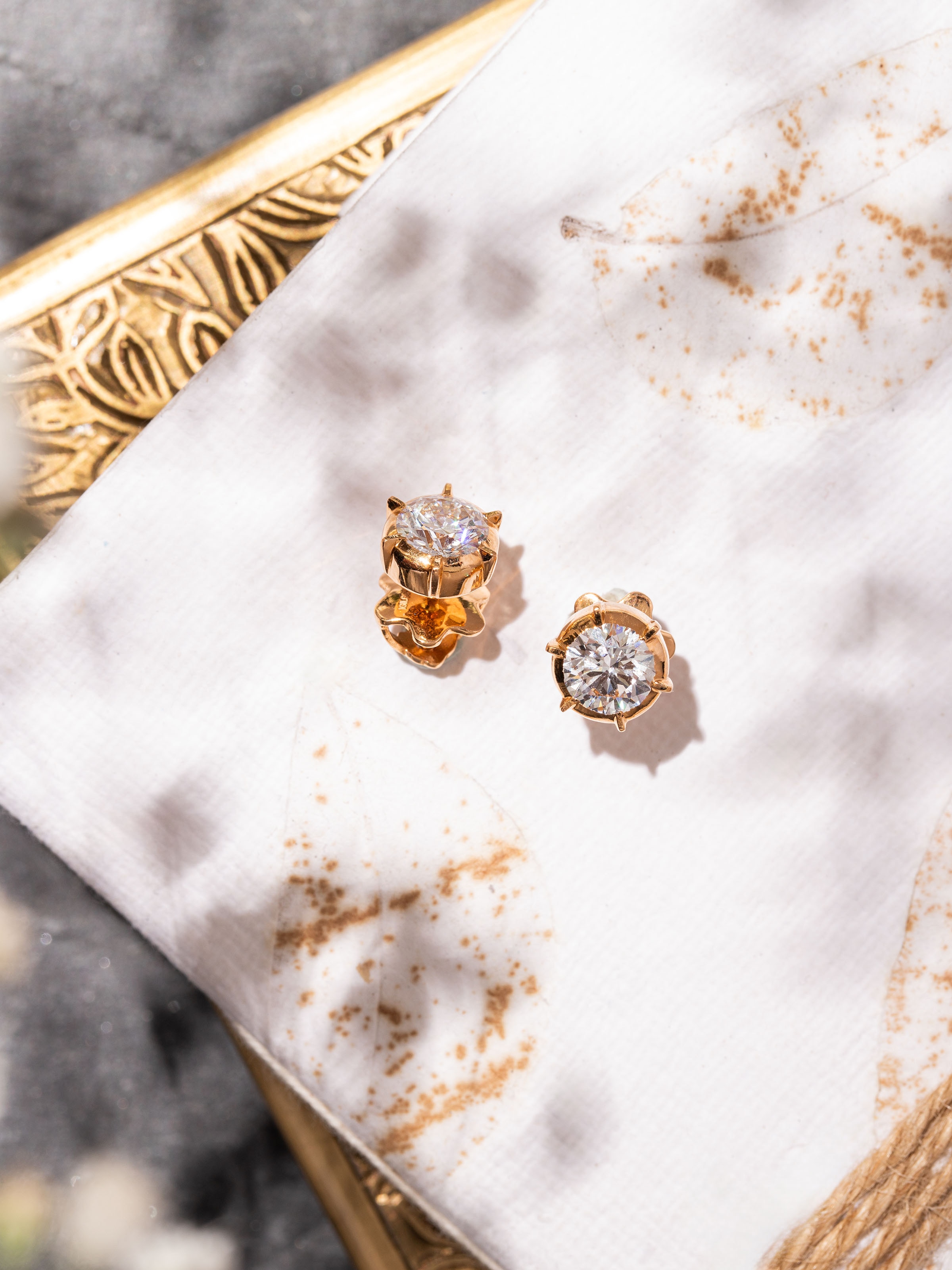 Side angle showing the rounded shape and smooth edges of gold studs