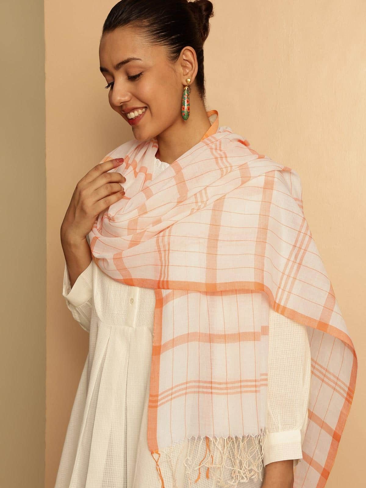 Close-up of orange cotton stole fabric highlighting its weave and fine texture