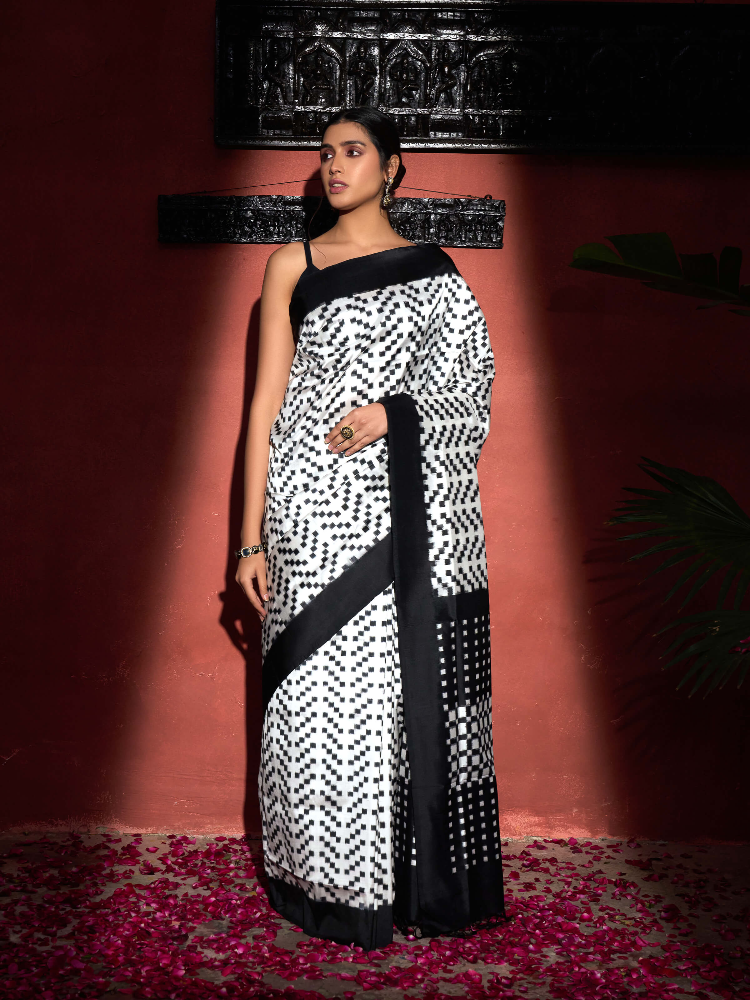 Side view of black silk double ikat saree with fluid drape and traditional border