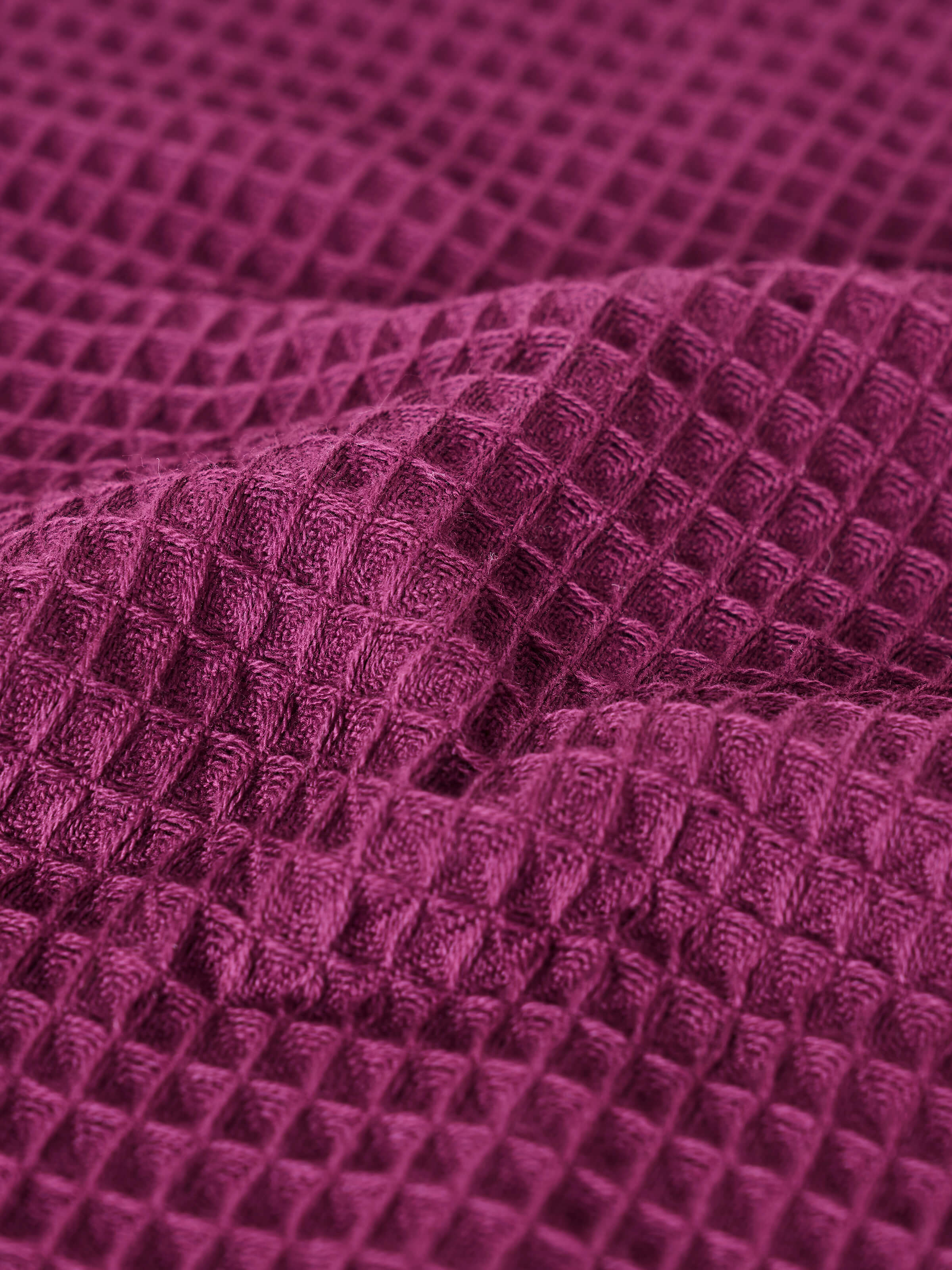 Close-up of waffle weave texture on purple cotton hand towel