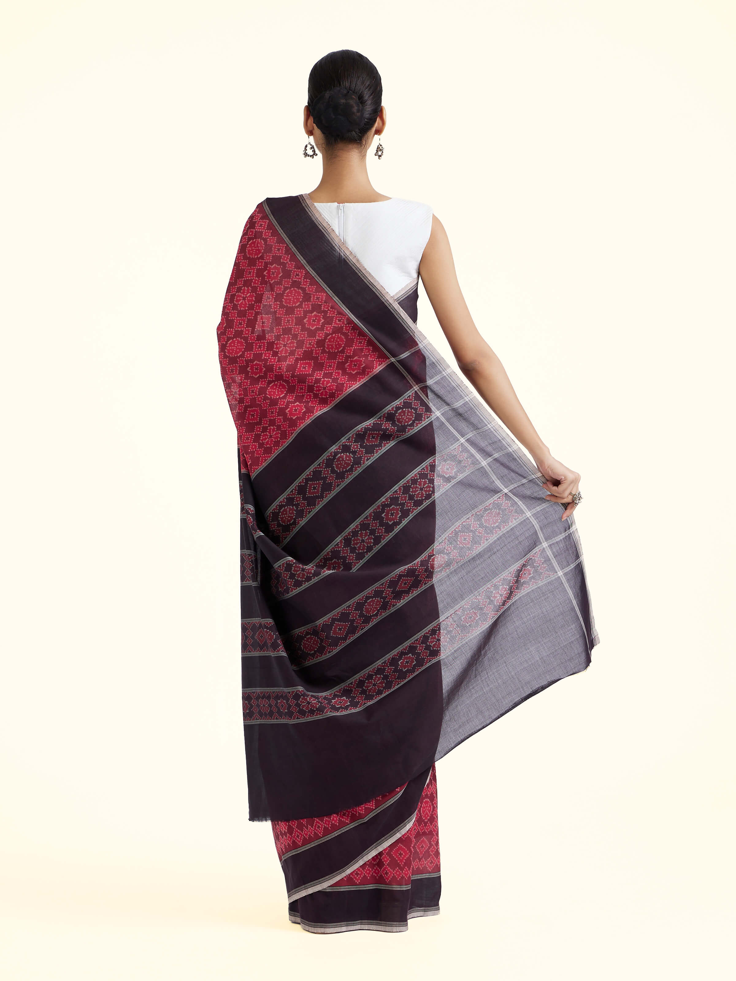 Back view of maroon mulberry silk ikat saree displaying pallu design