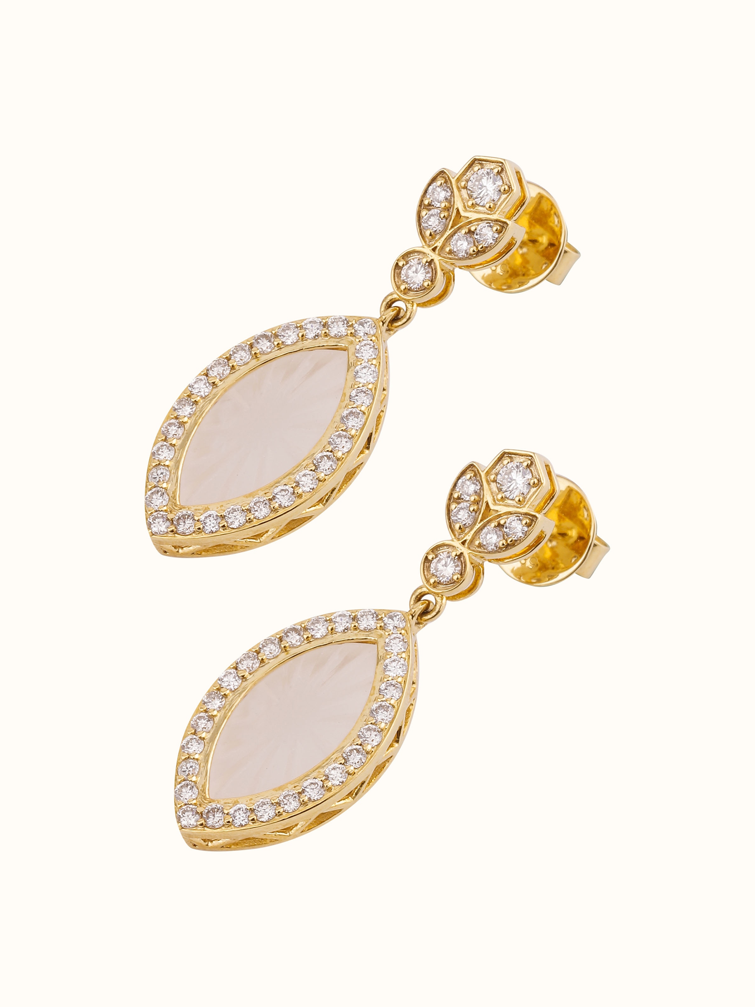 Worn view of lapidary 14 karat gold drop earrings