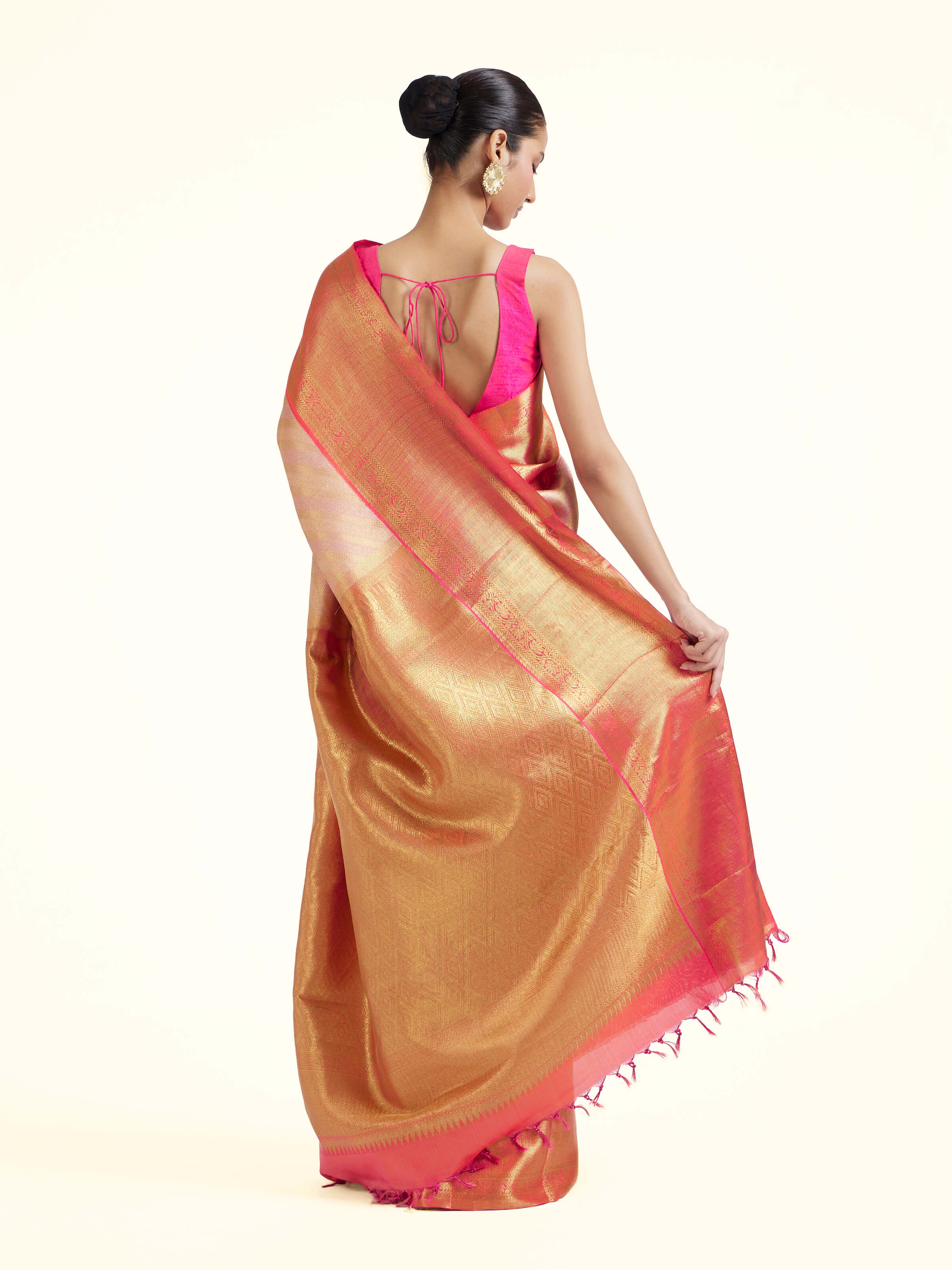 Back view of light pink silk Kancheepuram saree displaying ornate pallu design