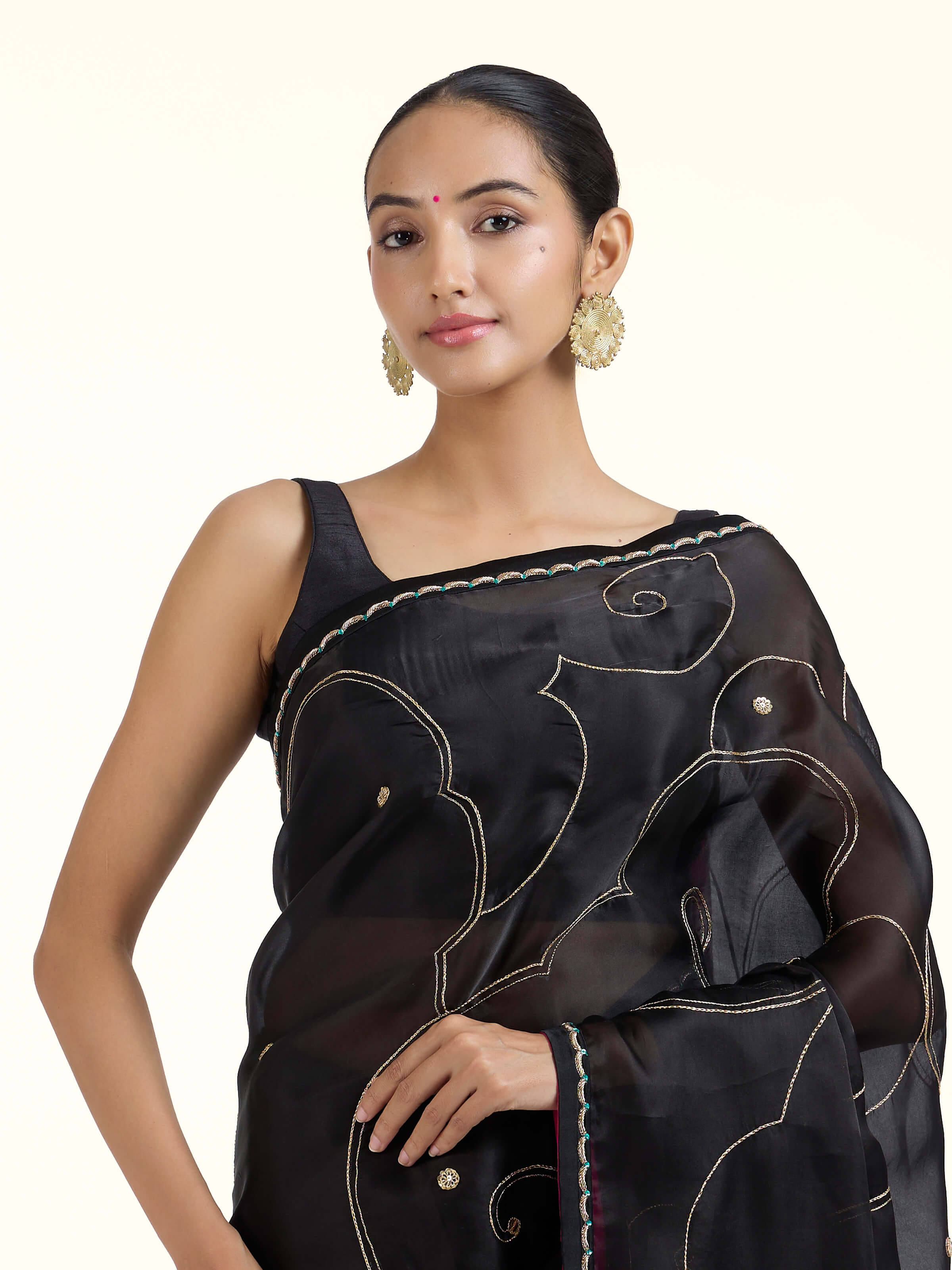 Angled view of black silk zardozi saree highlighting embroidery and sheen