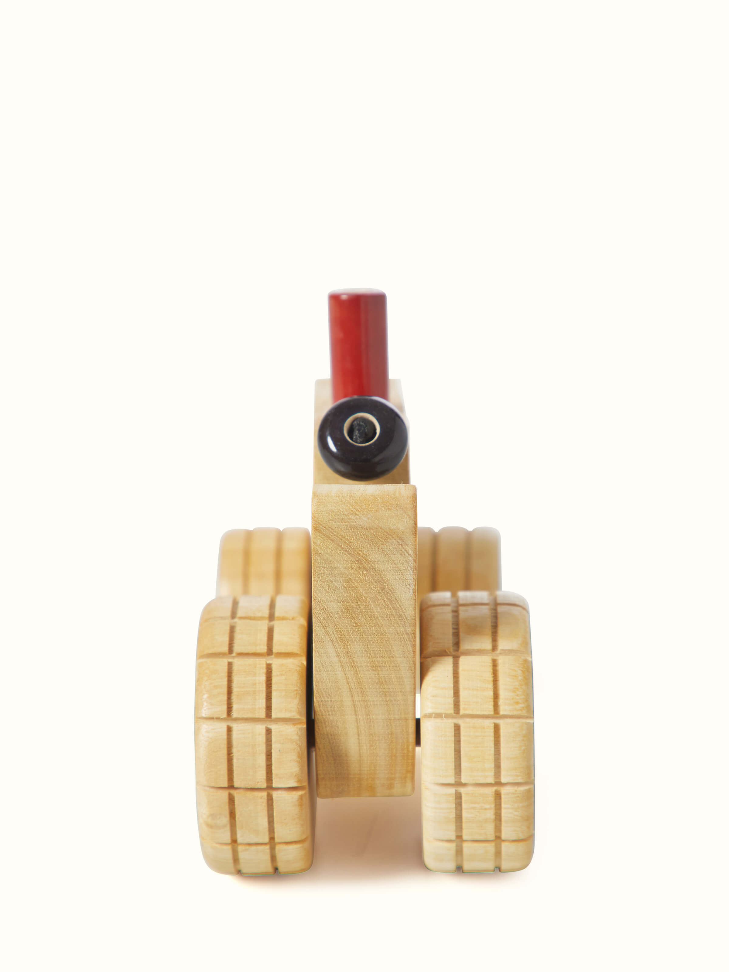 Rear view of white Channapatna ivory wood tractor toy showing the back design