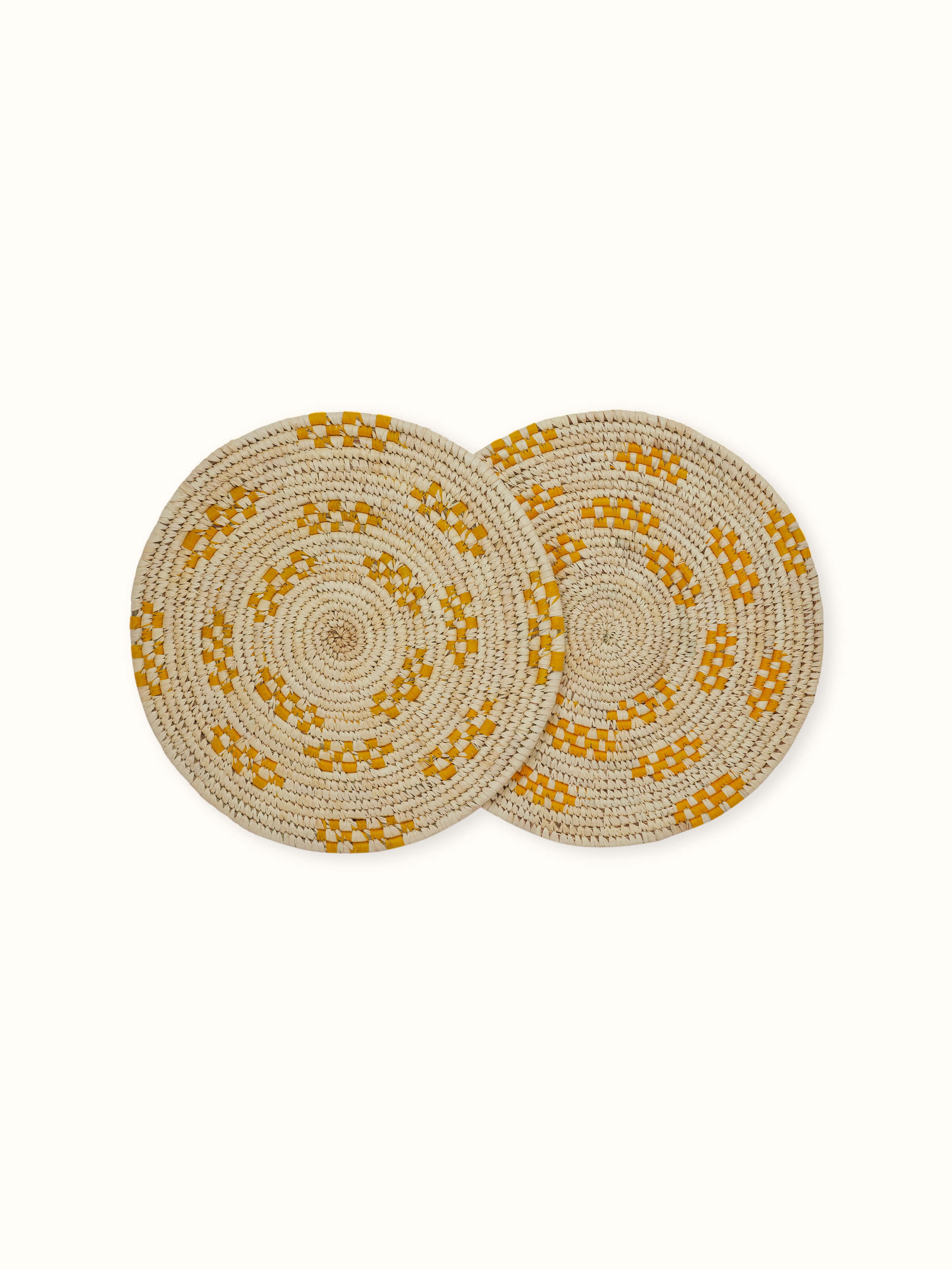Top view showing the round yellow natural fibre Sabai grass table mats (2 pieces)