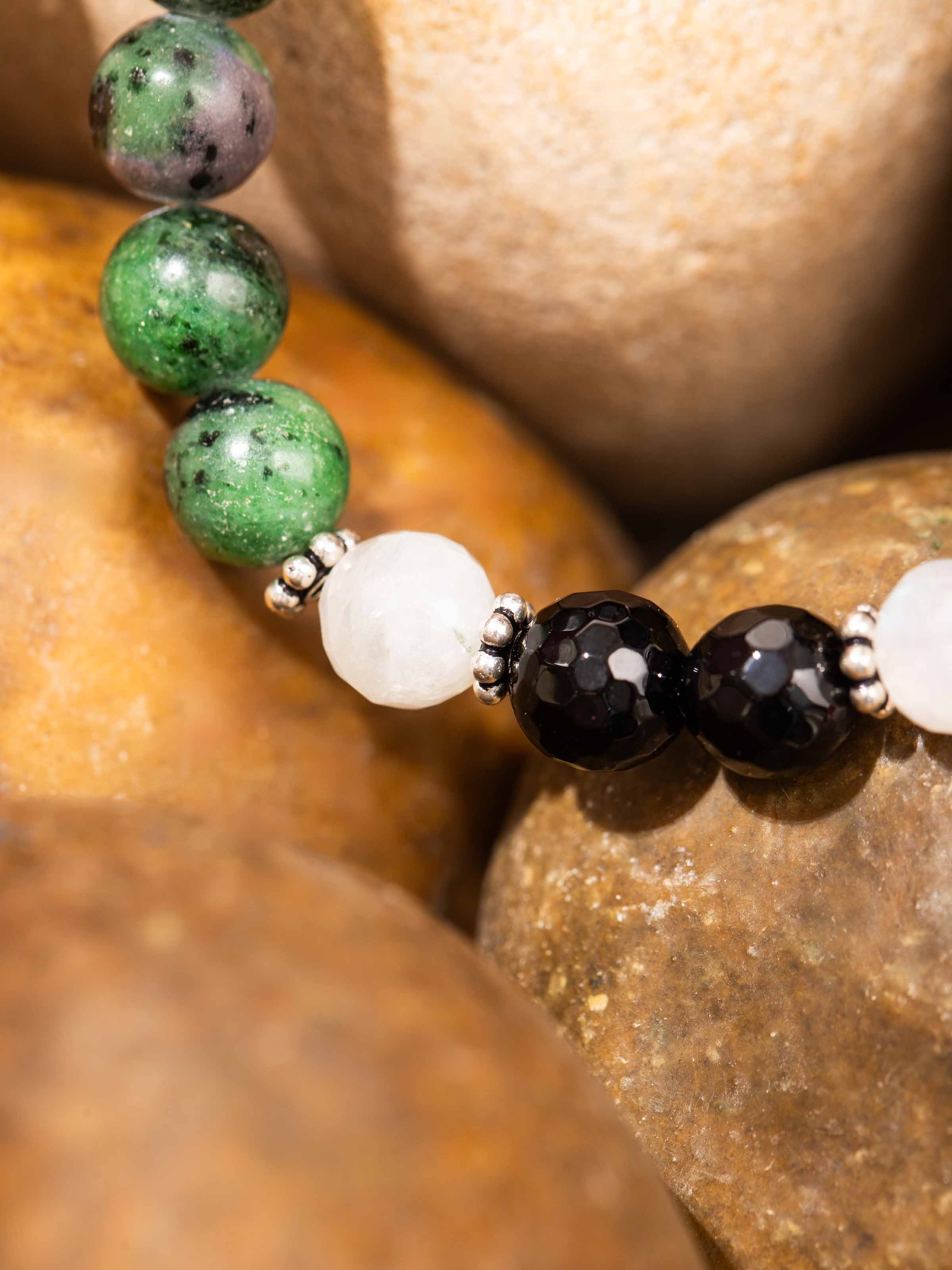 Detailed shot of Malachite, Onyx & Moonstone Bracelet, focusing on the rich hues and polished finish