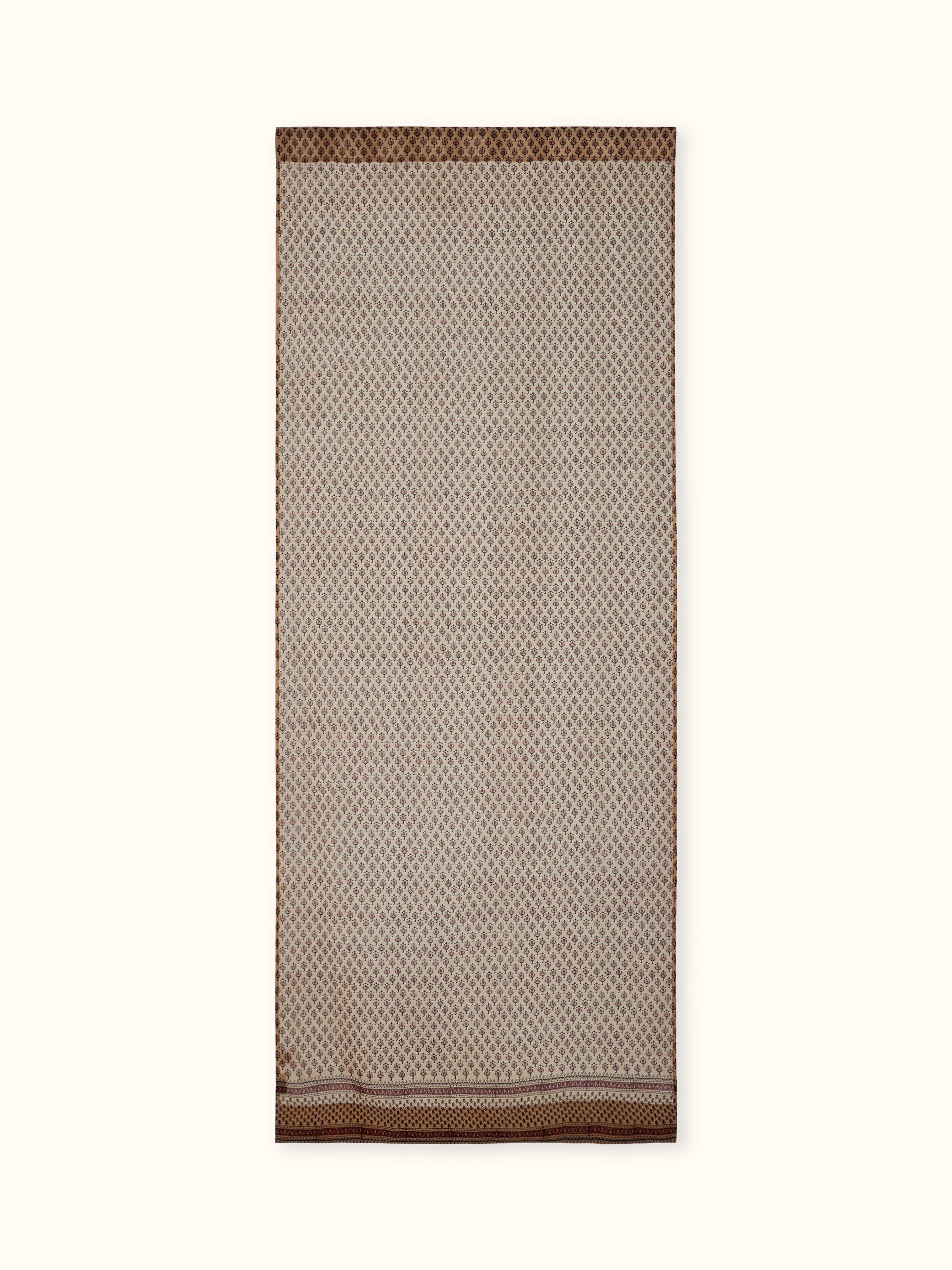 Front view of rust-colored sheer curtain featuring Bagru hand block printed buti on cotton silk blend.