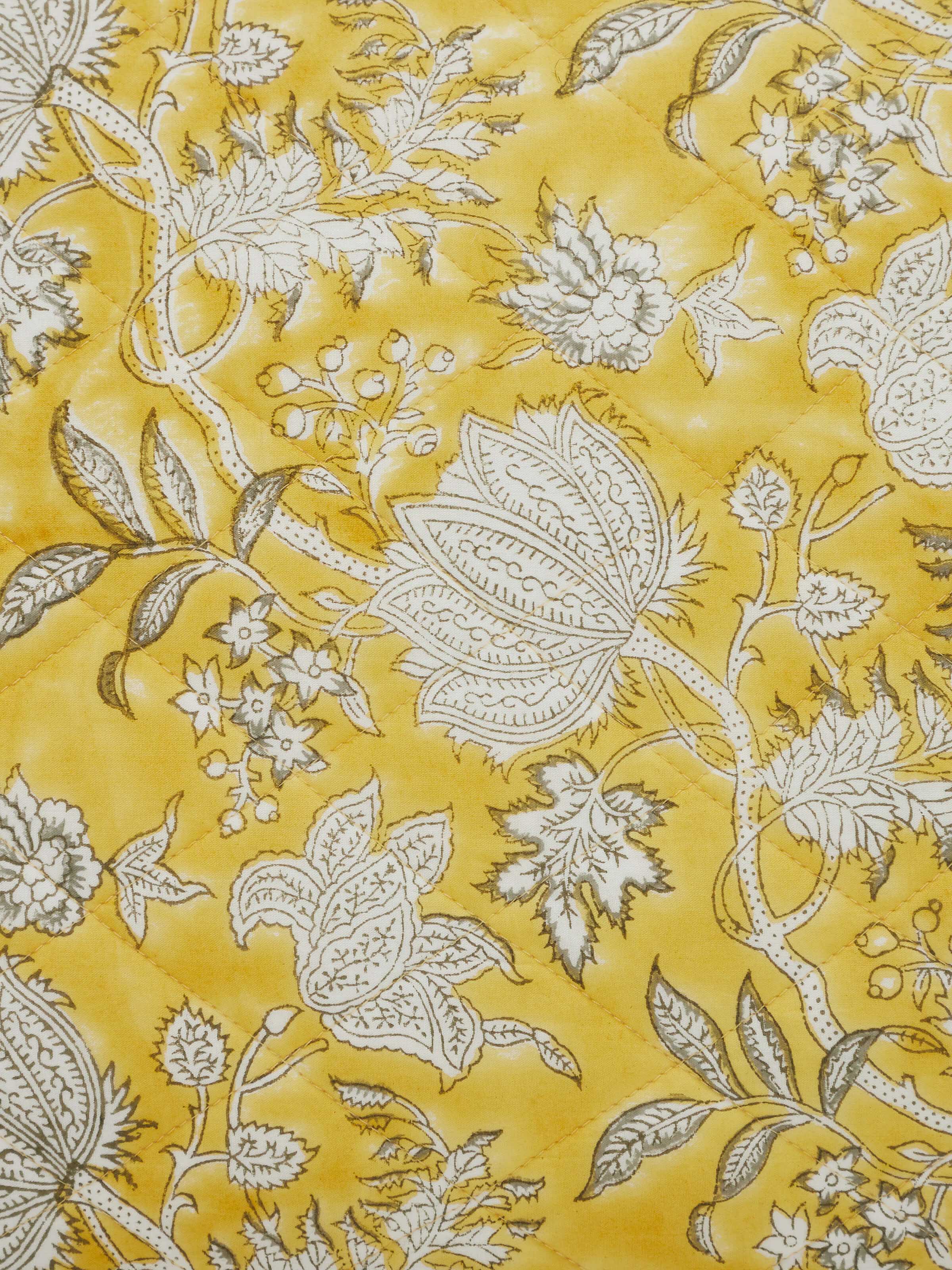 Detail shot of hand block print on Kairavam Yellow Floral Quilted Bedspread Set, showcasing intricate Sanganeri craftsmanship by Swadesh
