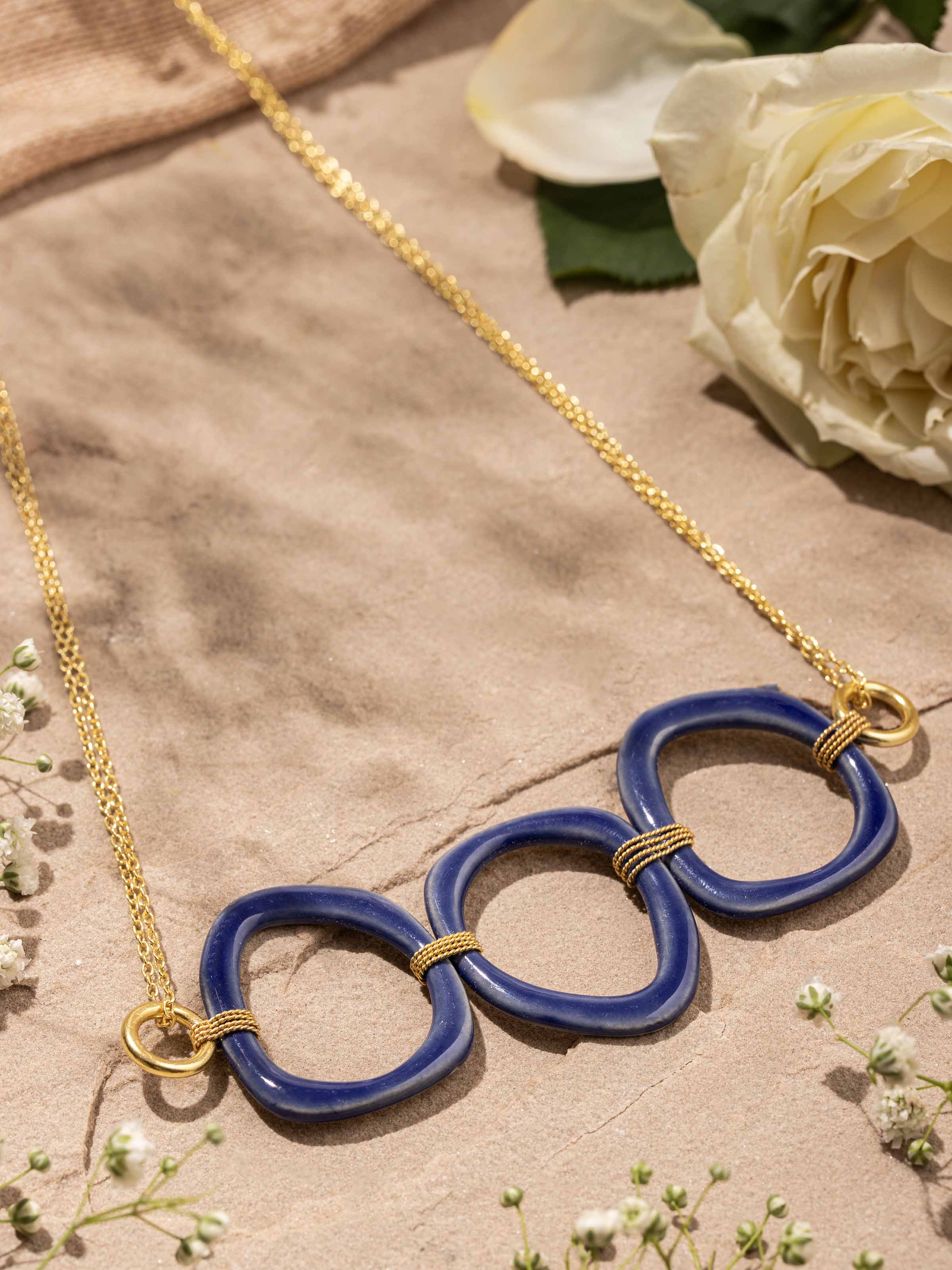 Close-up view of ceramic long necklace highlighting handcrafted textures and intricate beadwork