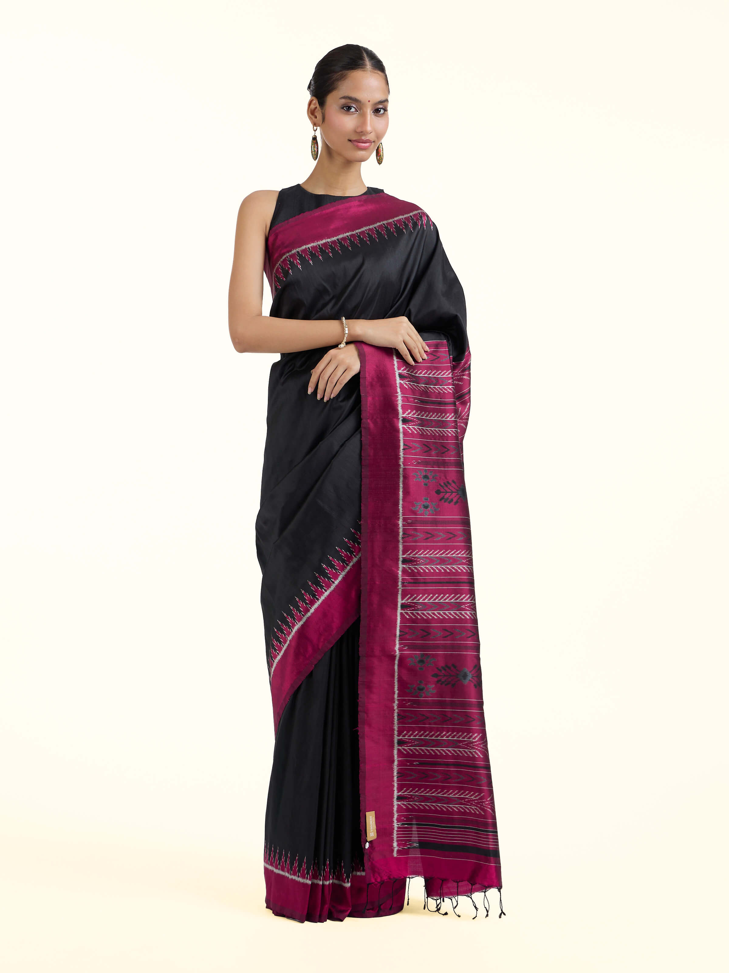 Front view of black mulberry silk Odisha ikat bandha saree showcasing traditional motifs