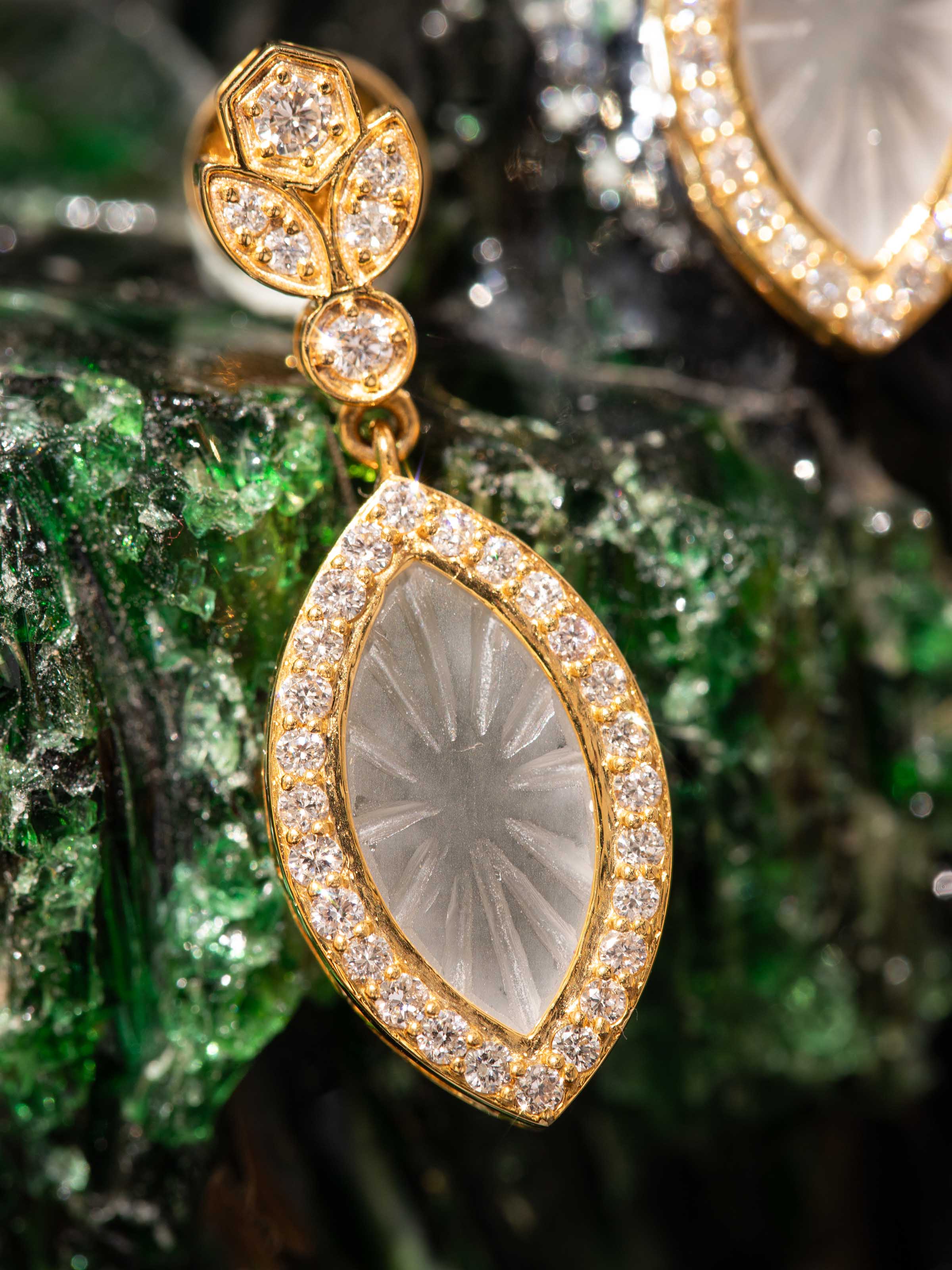 Detail shot of lapidary 14 karat gold drop earrings