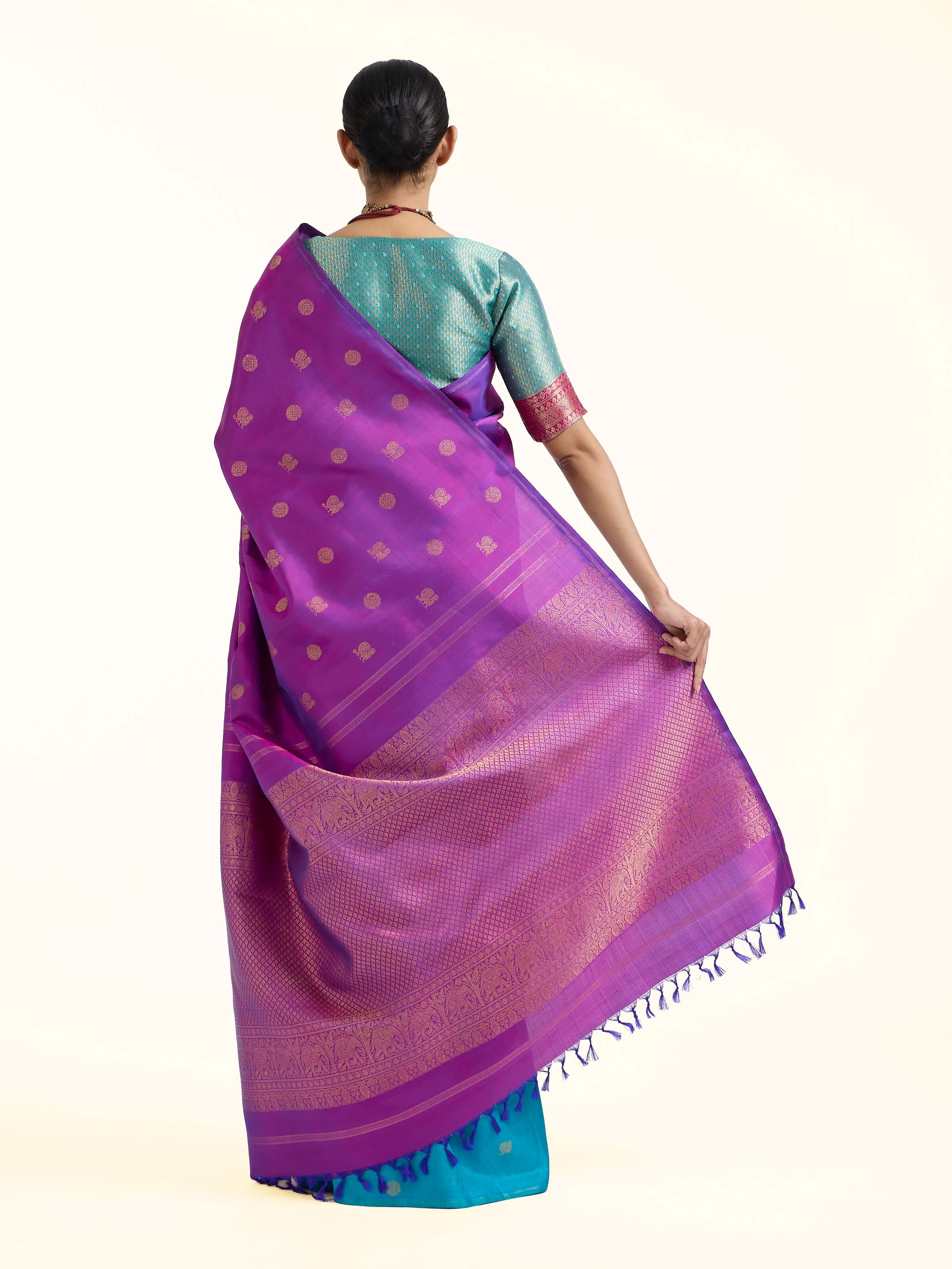 Back view of purple silk Kancheepuram saree displaying ornate pallu