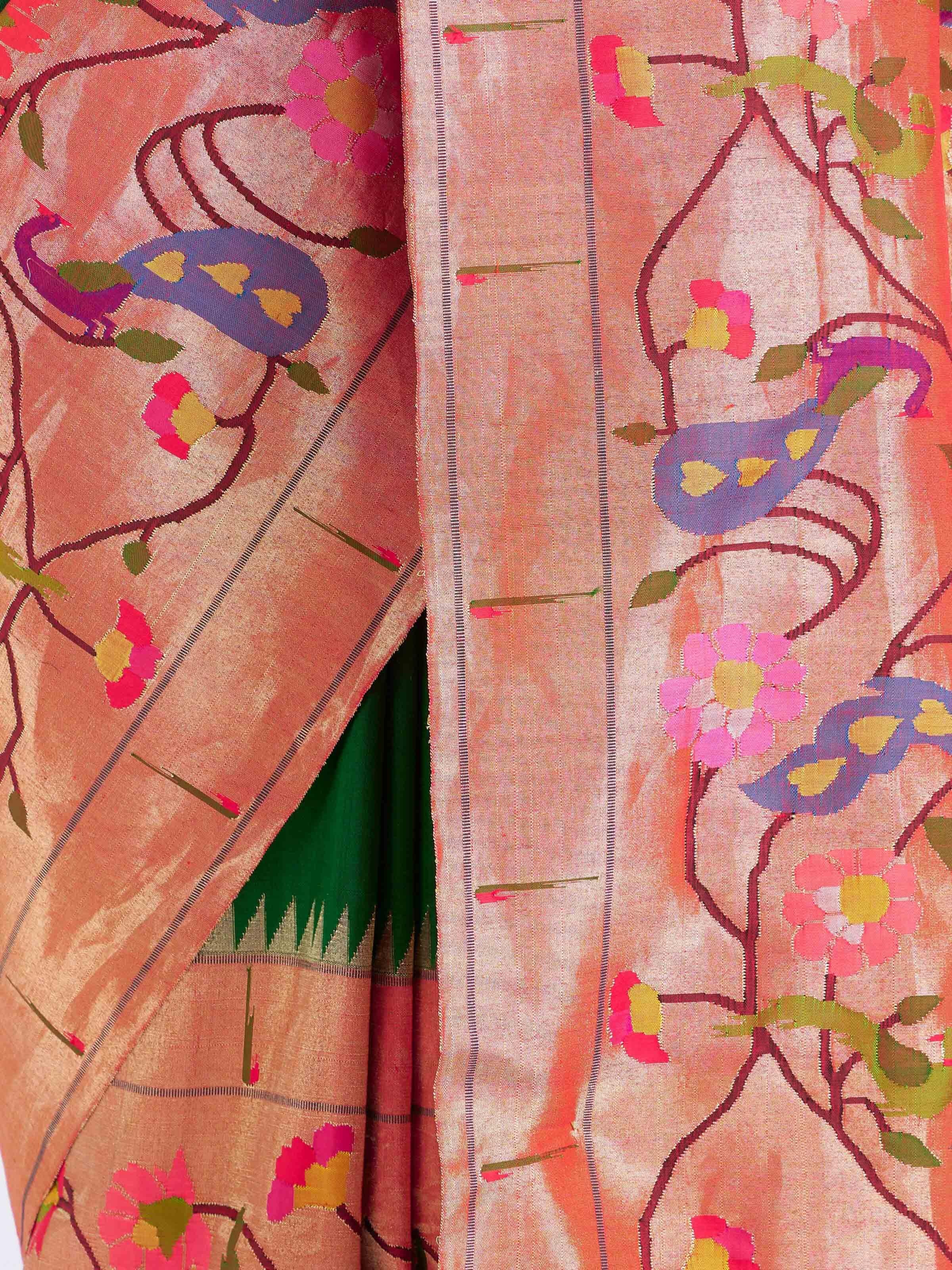 Detail view of green silk Paithani saree showcasing intricate zari craftsmanship