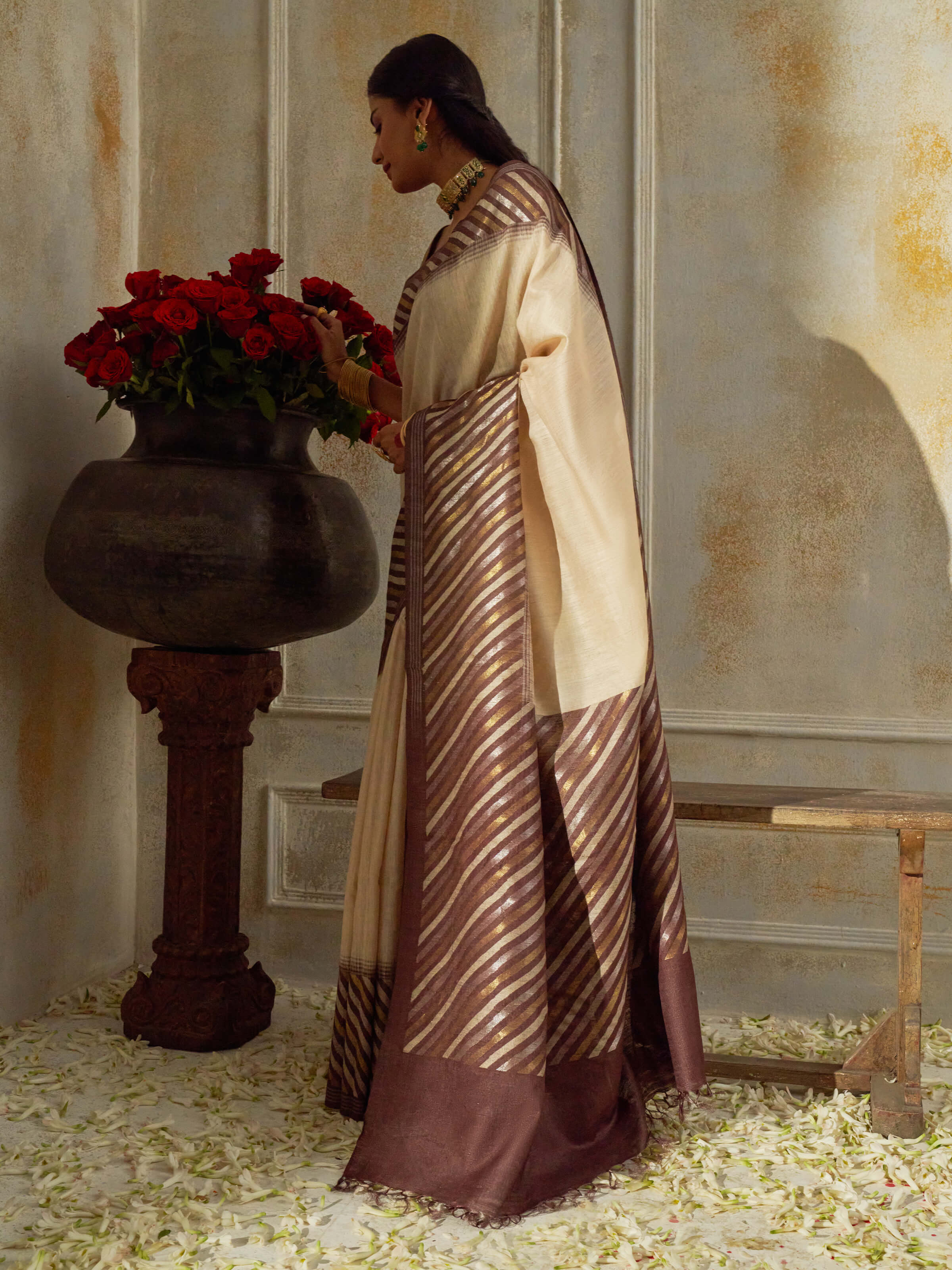 Angled view of beige tussar muga silk saree highlighting woven patterns