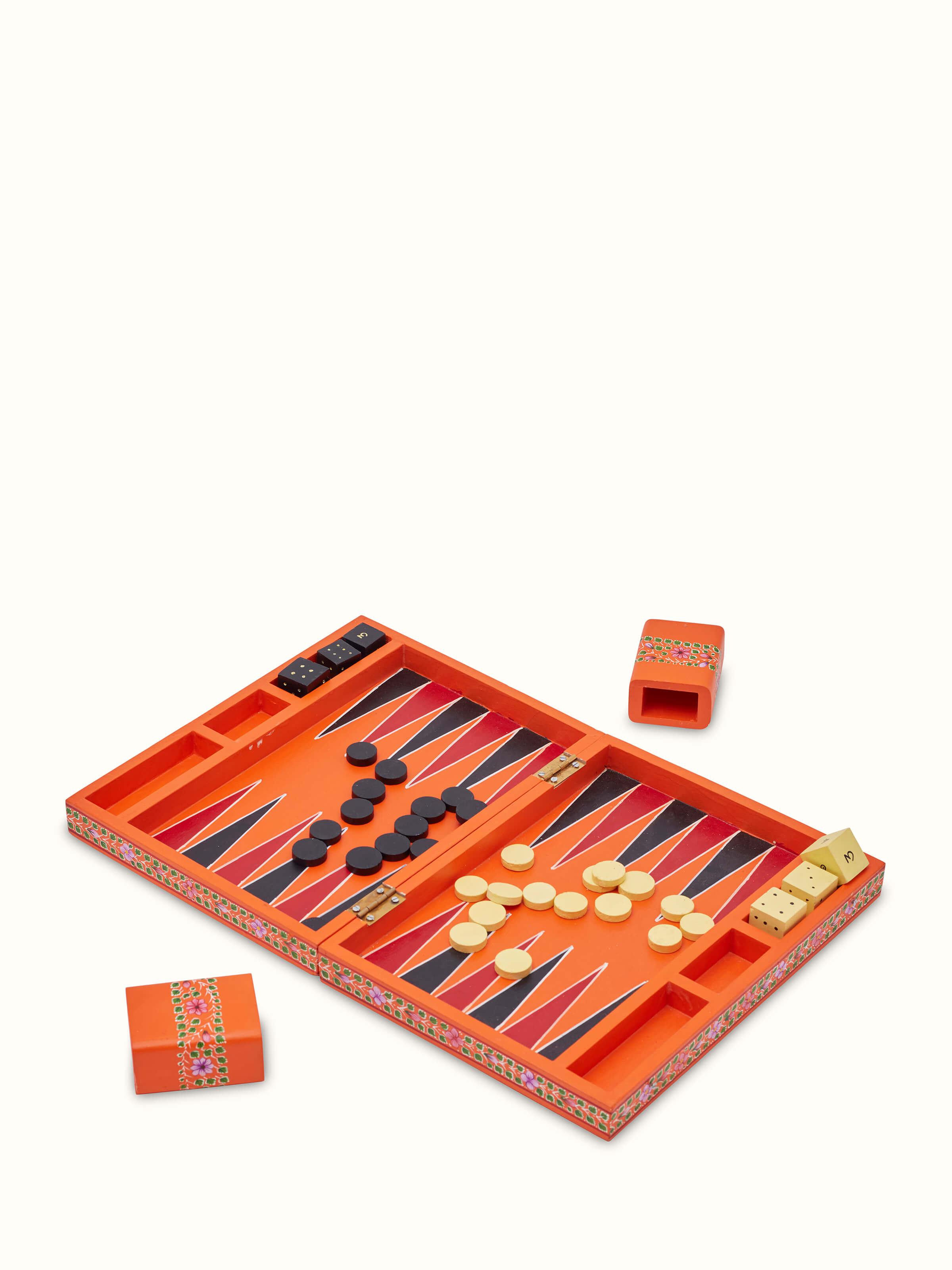 Detailed view of Ganjifa cedar wood backgammon in orange focusing on the craftsmanship and design elements