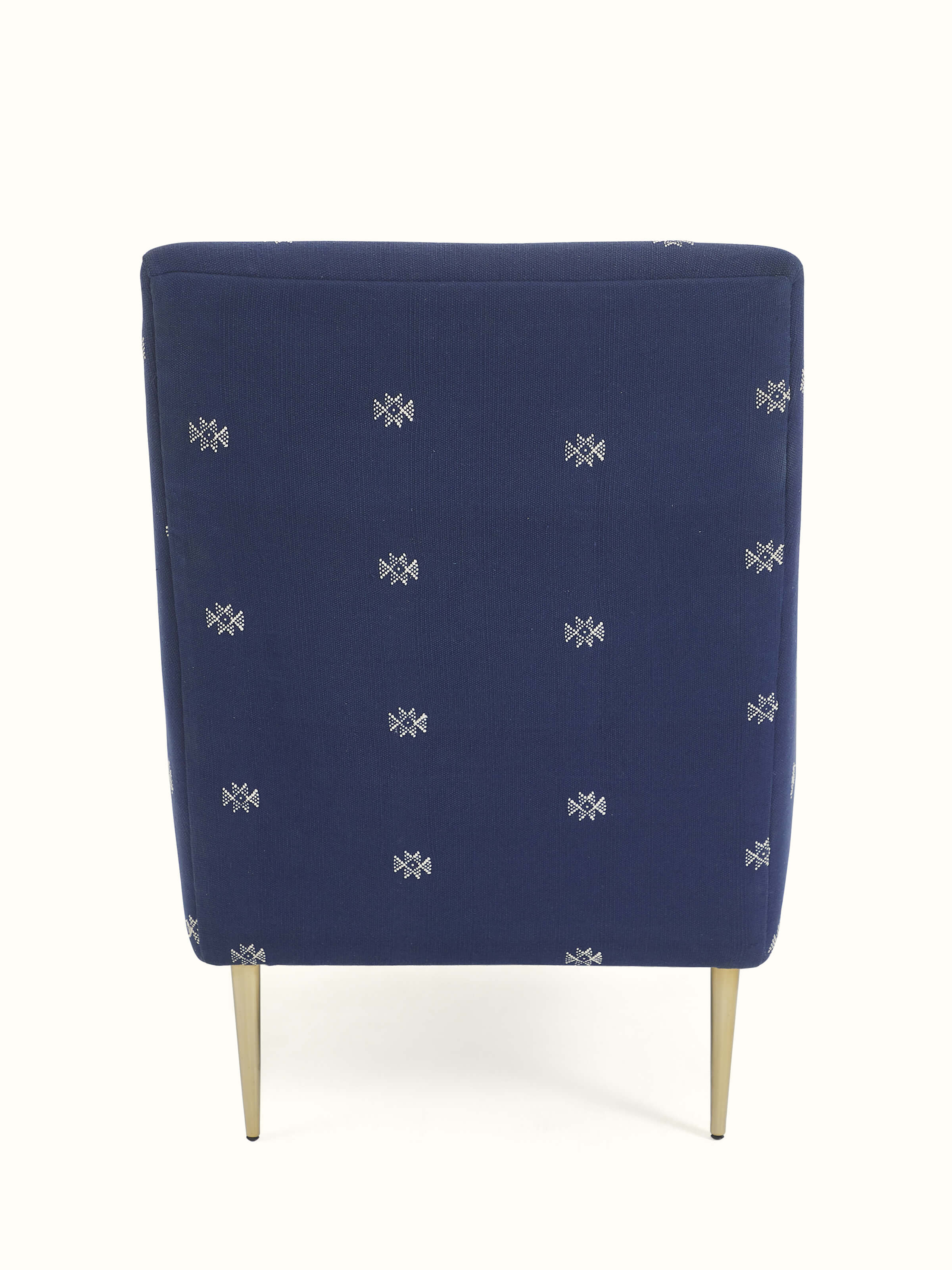 Back view of Upholstered Metal Wing Chair, highlighting its elegant wings and refined design