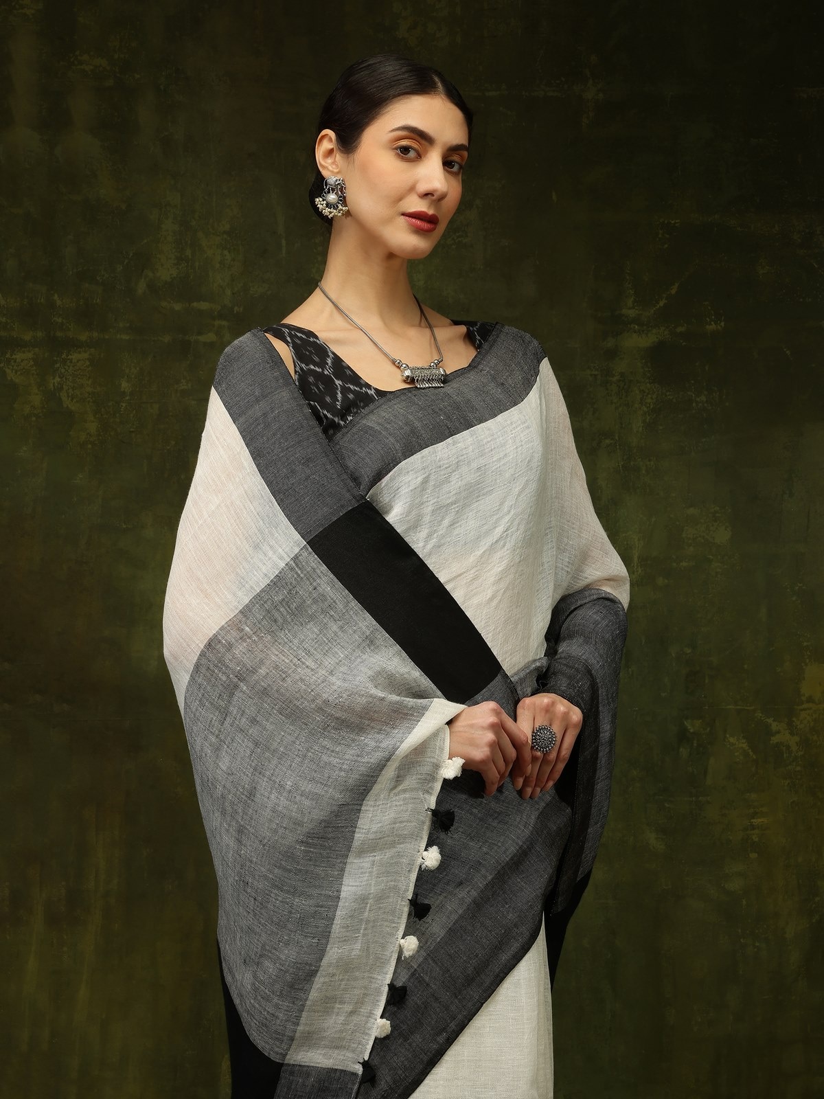 Overhead view of black linen saree showcasing elegant folds and solid color