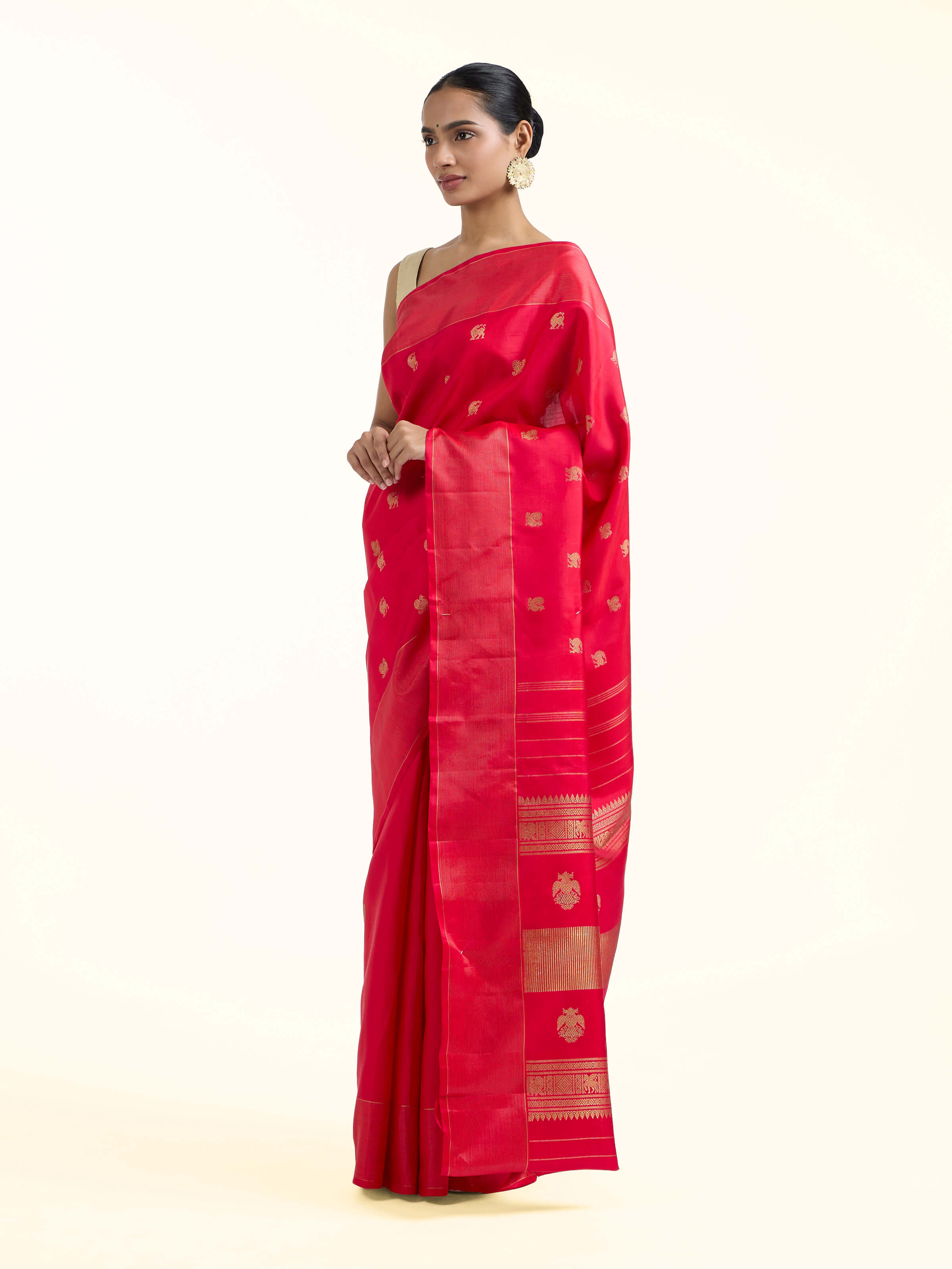 Side view of red silk Kancheepuram saree showcasing contrast border