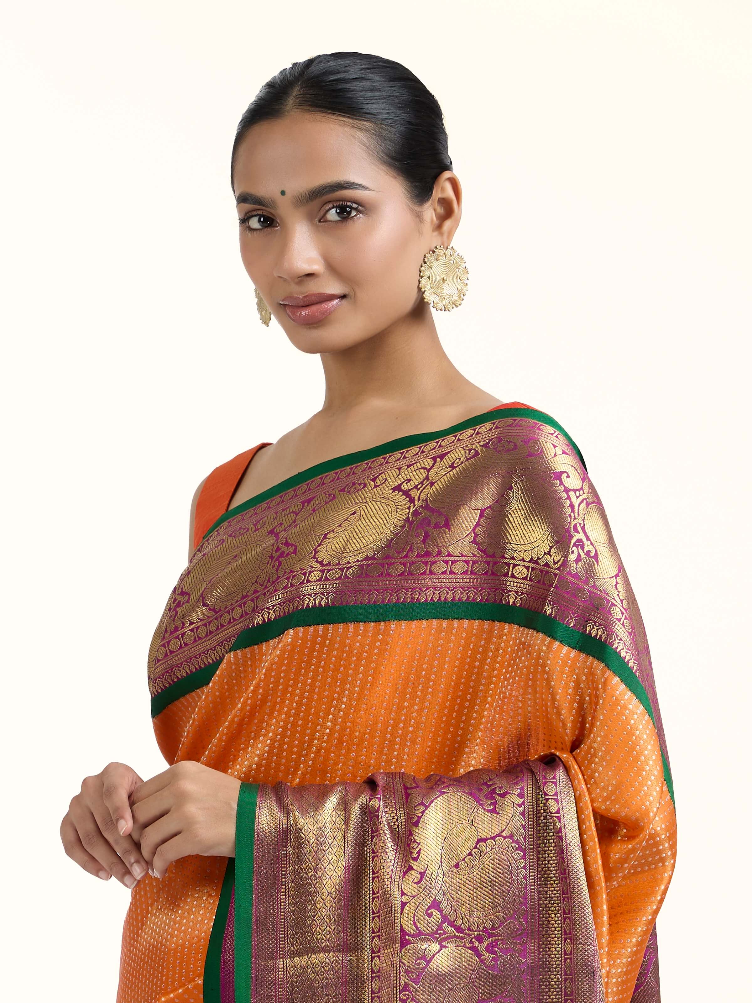 Angled view of mango silk Kancheepuram saree highlighting rich weave