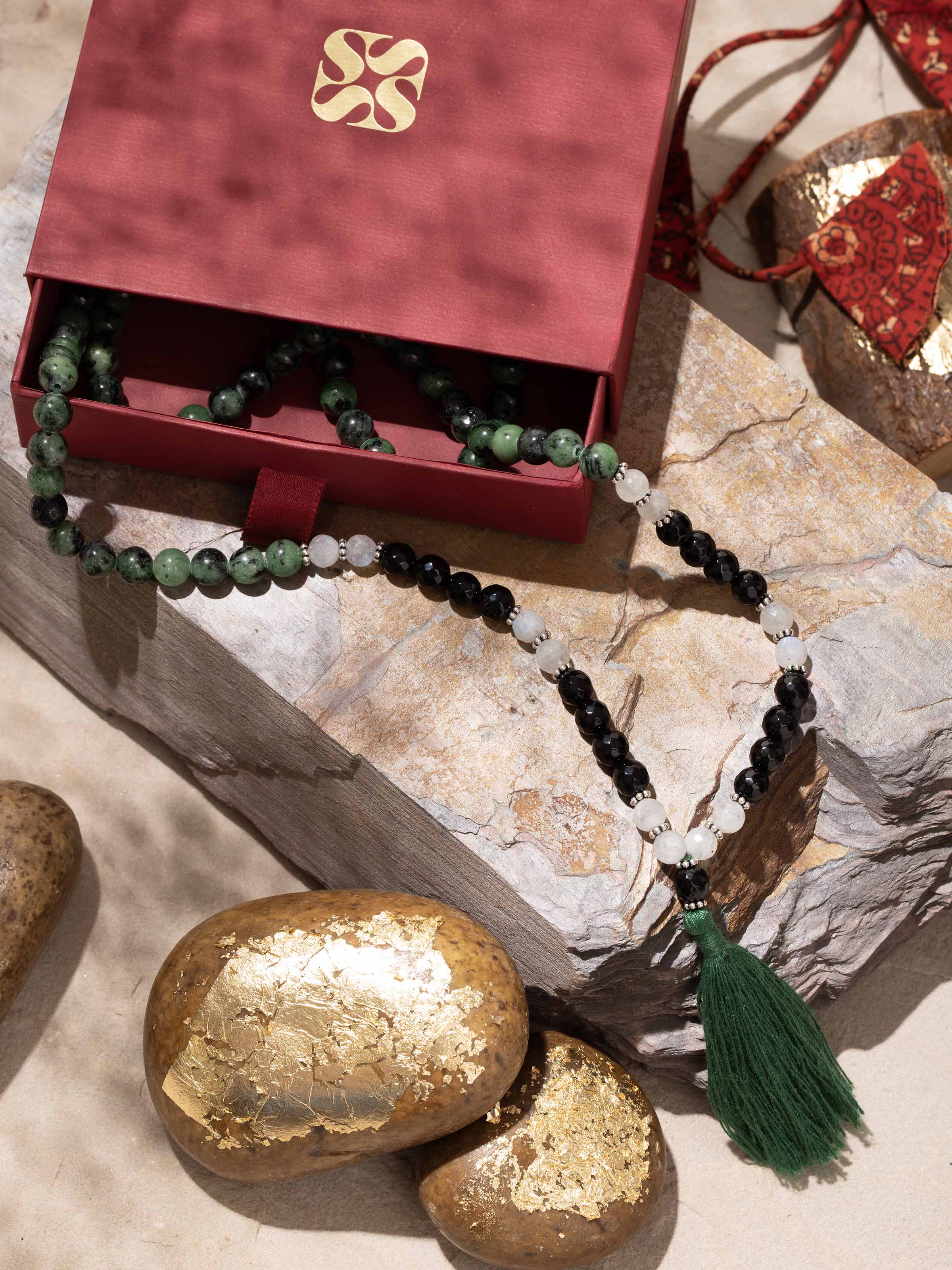 Lifestyle view of Rubicozite, Onyx & Moonstone Mala worn for spiritual balance and aesthetic grace