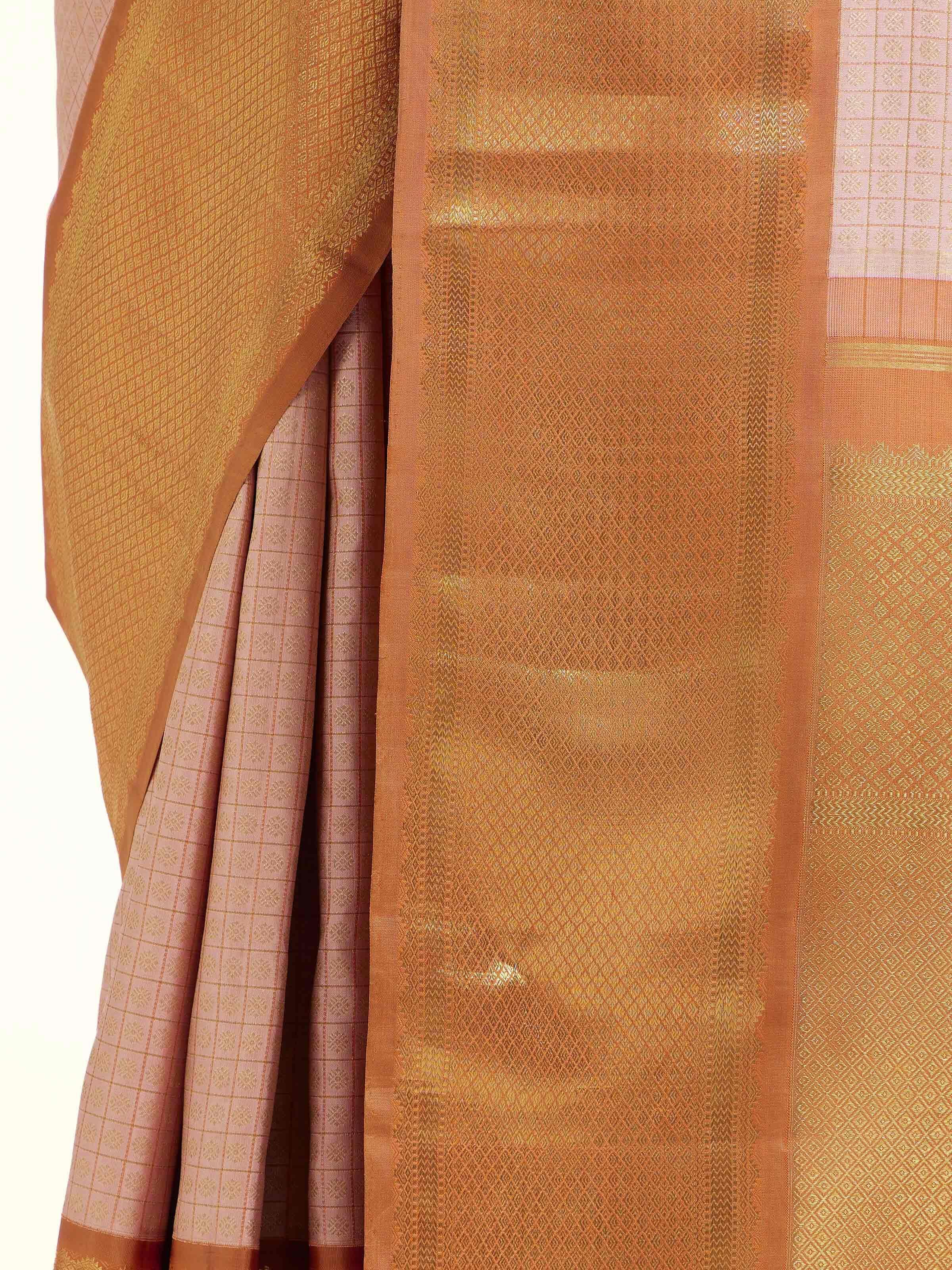 Detail view of pink silk Kancheepuram saree showing silk texture and zari craftsmanship