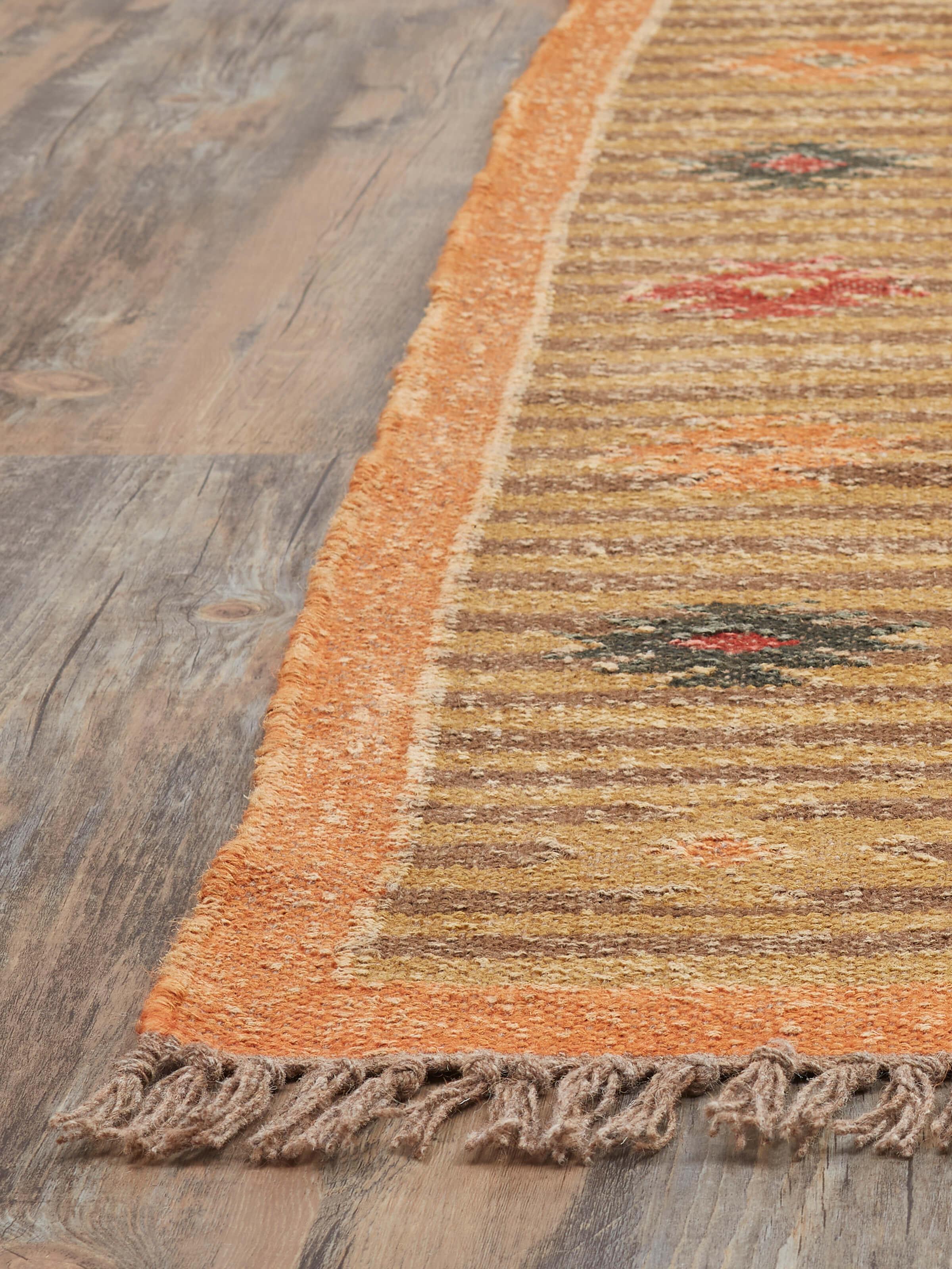 Angle view of Traditional Kilim rust Lawan jute and wool Panja dhurrie displaying its vibrant color and traditional design