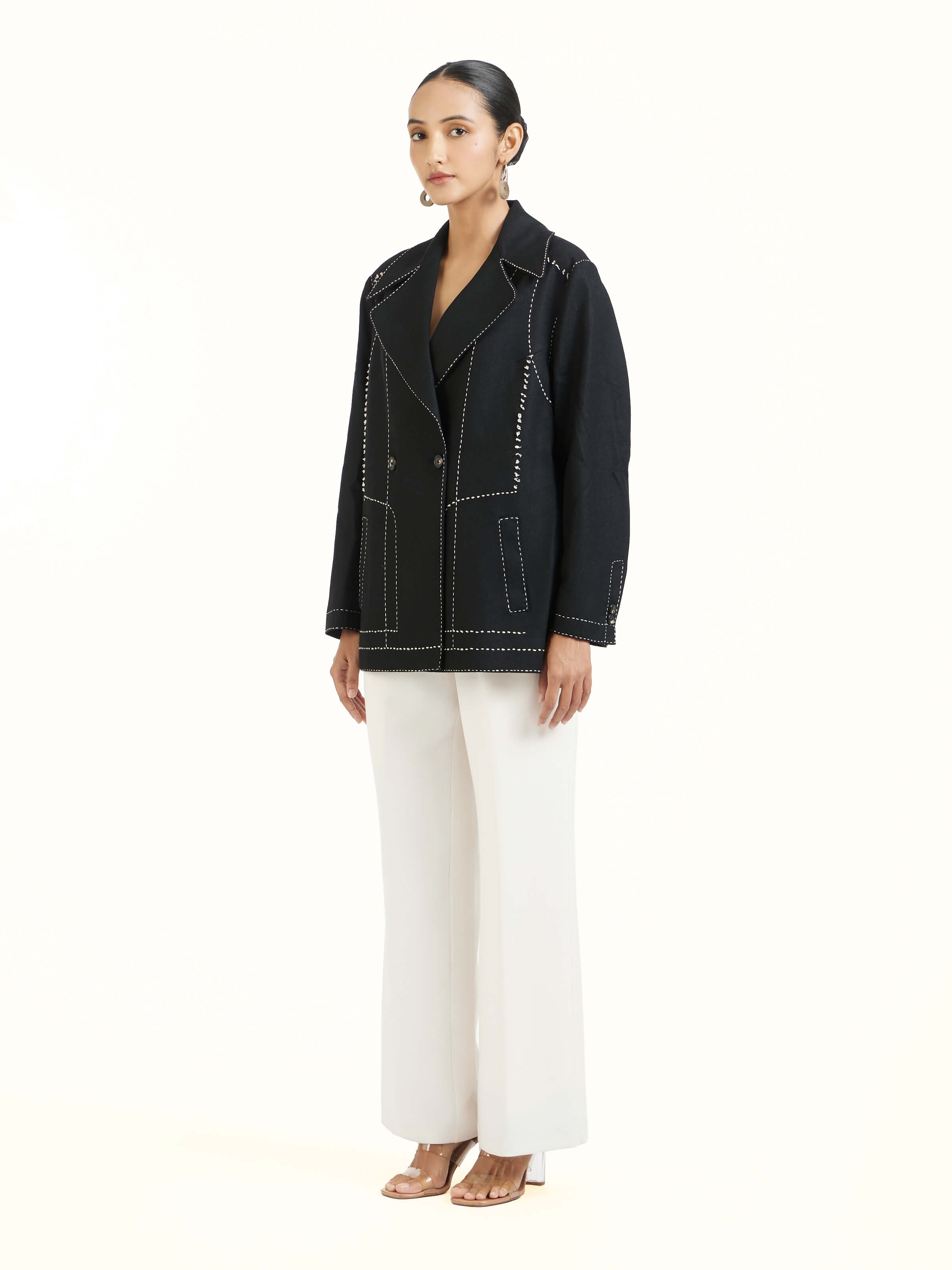 Side view of black wool kantha jacket with structured silhouette