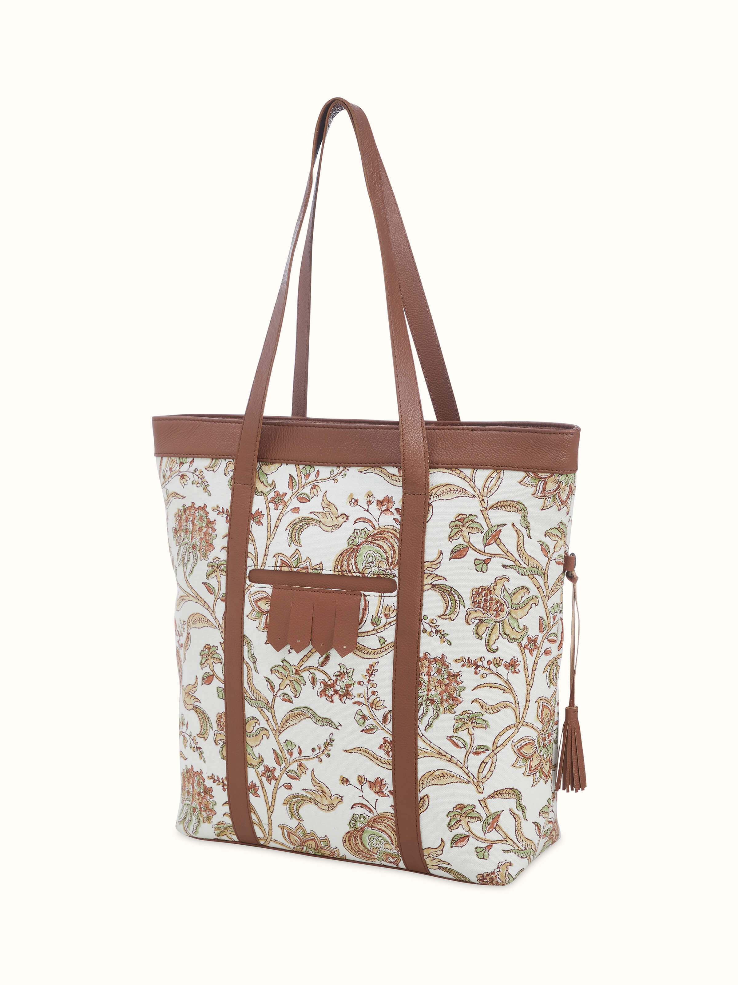 Close-up of hand block print and leather texture on mustard tote bag.