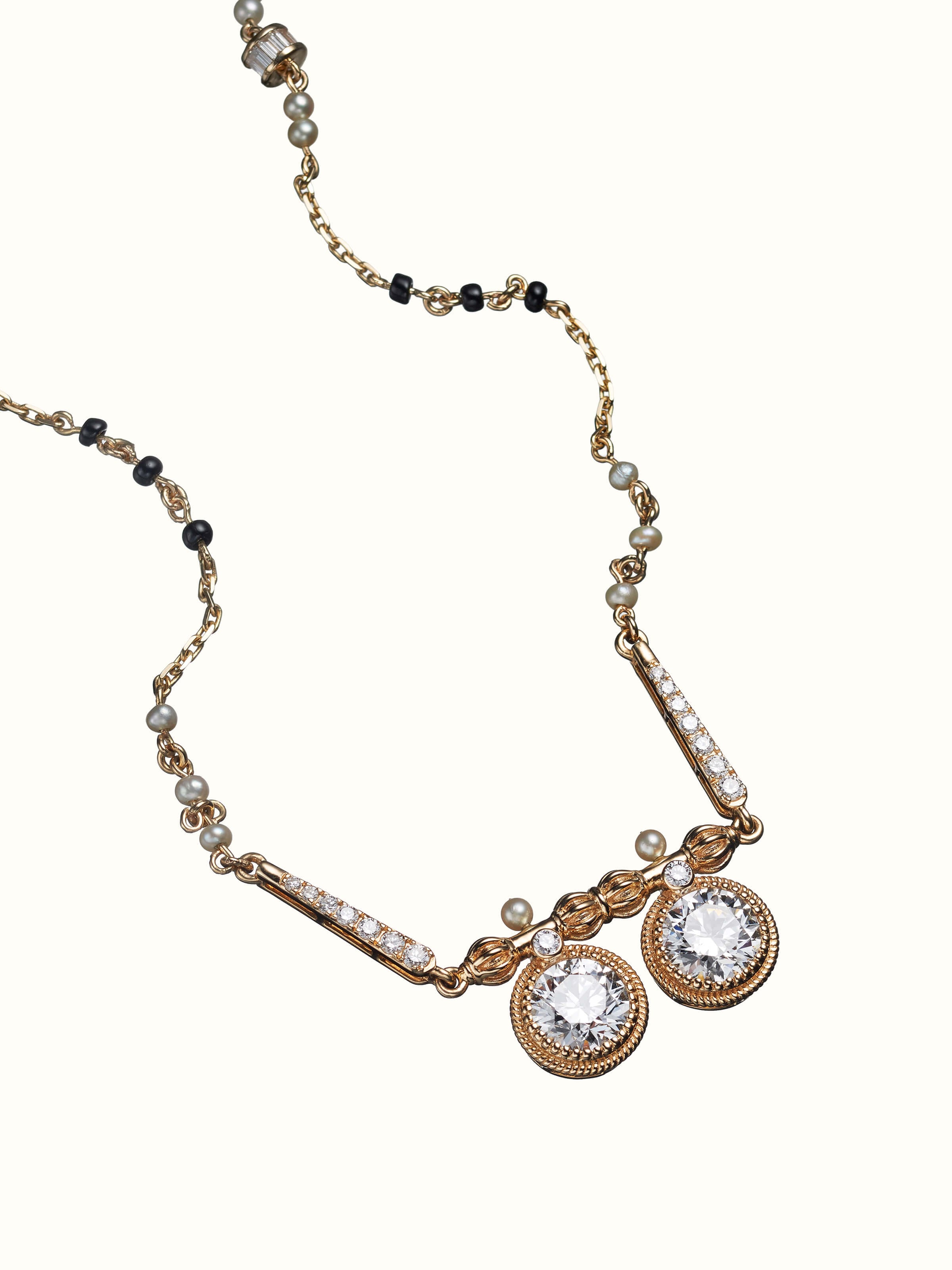 angled view of open setting 14 karat gold mangalsutra