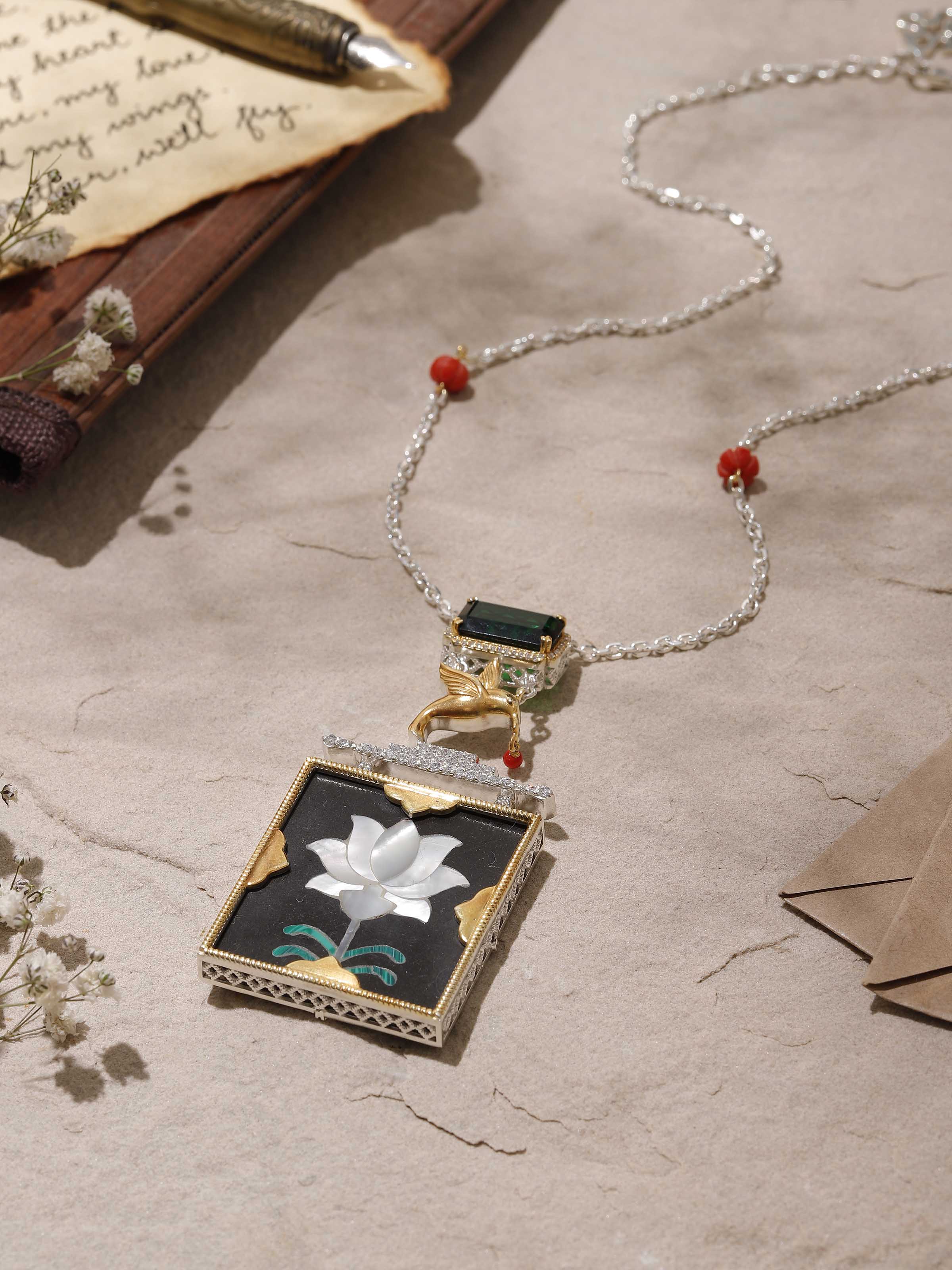 Close-up showing ornate carvings and texture on the silver pendant surface