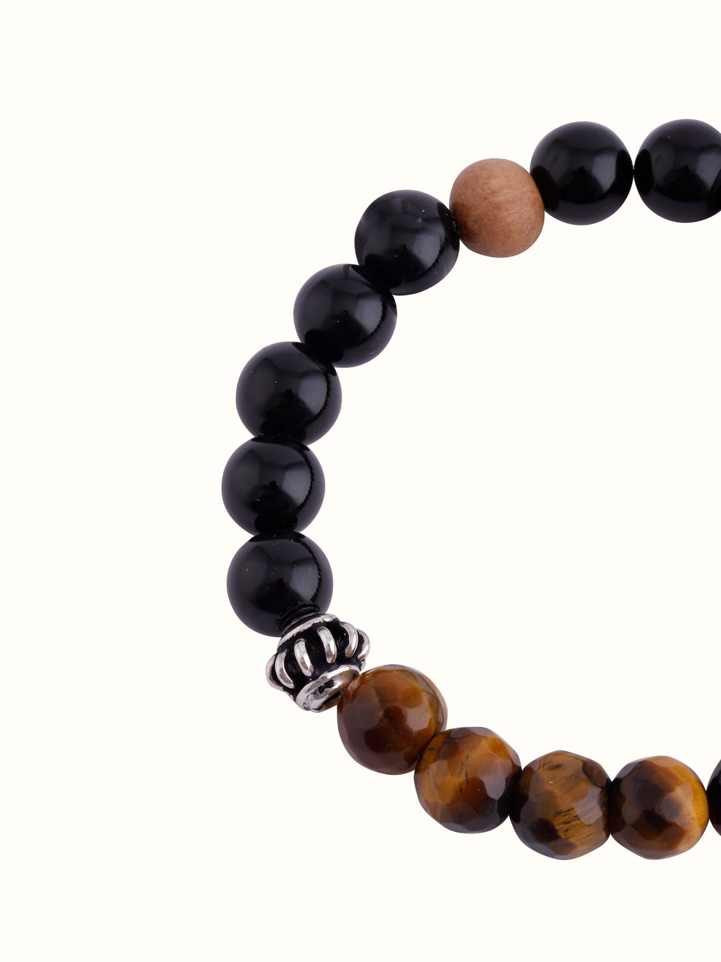 Overhead view of Tiger Eye, Onyx & Moonstone Bracelet focusing on elegant gemstone contrast and layout
