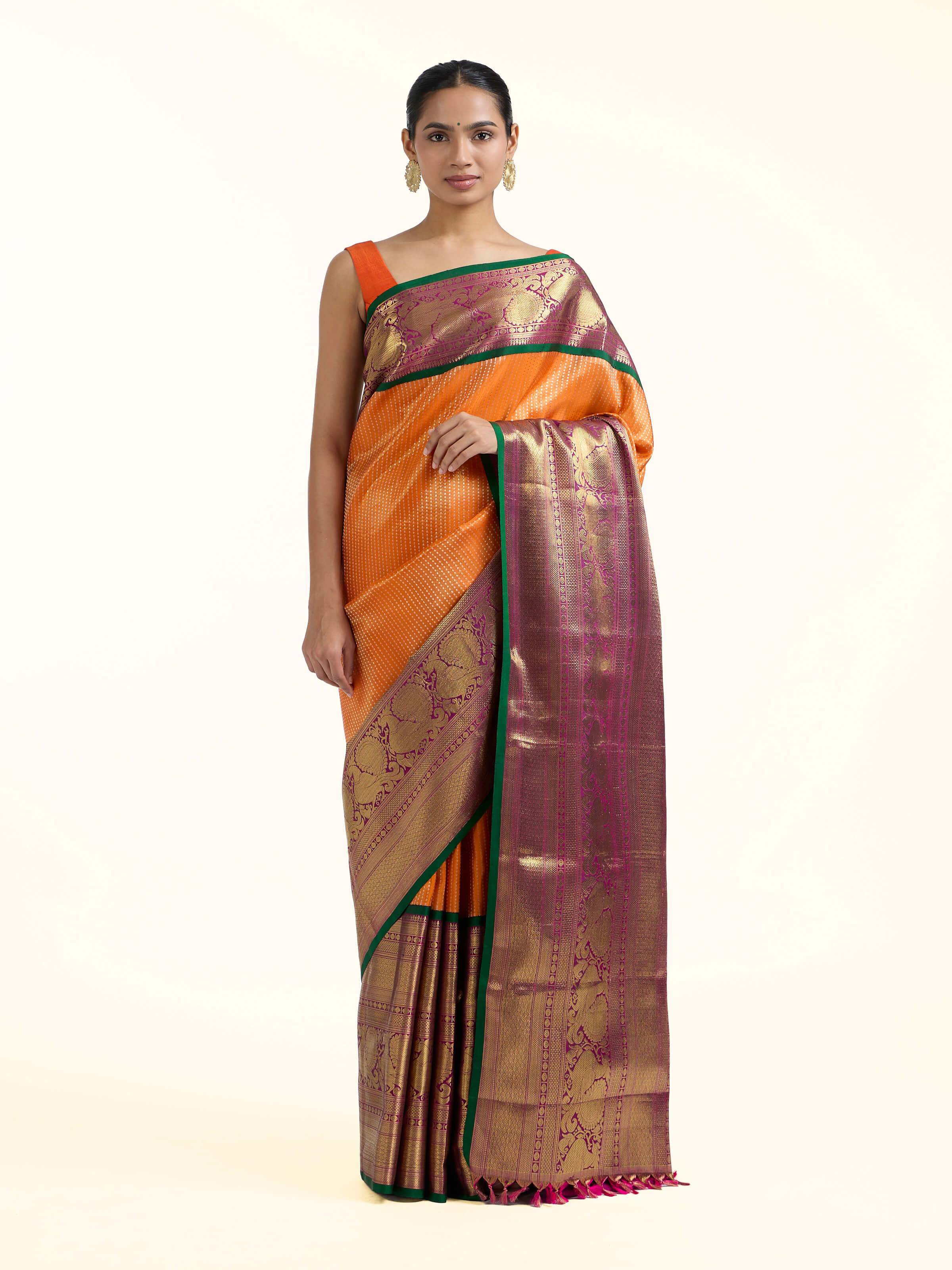 Front view of mango silk Kancheepuram saree with vibrant zari motifs