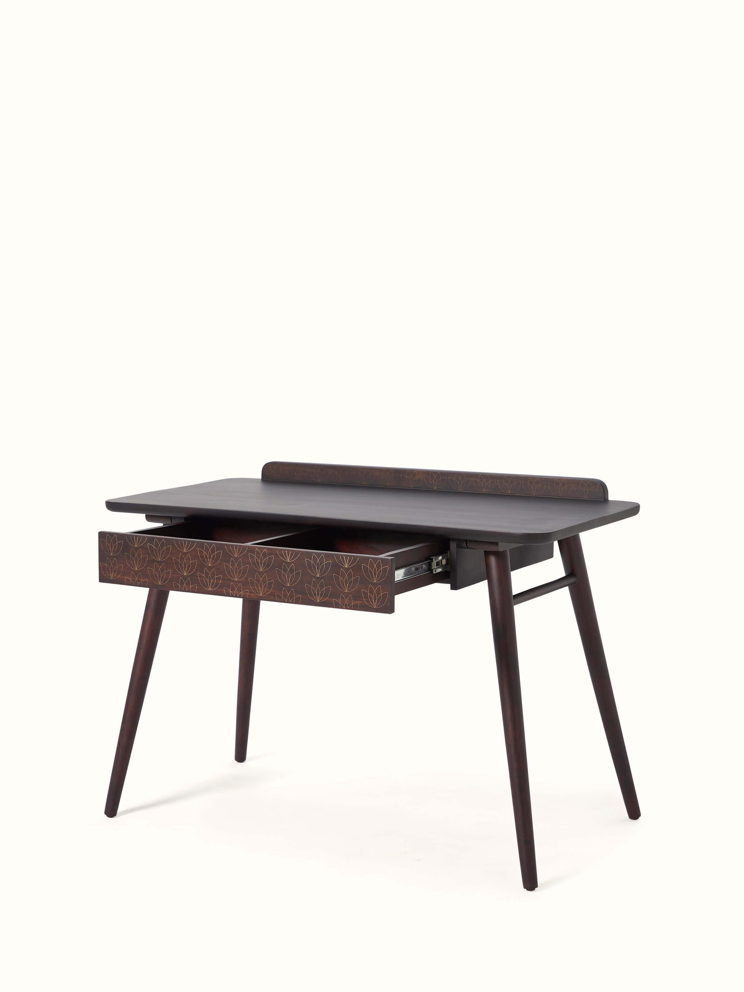 Angled view of Sheesham wood study table with brass tarkashi inlay, highlighting the smooth finish and ornate patterns