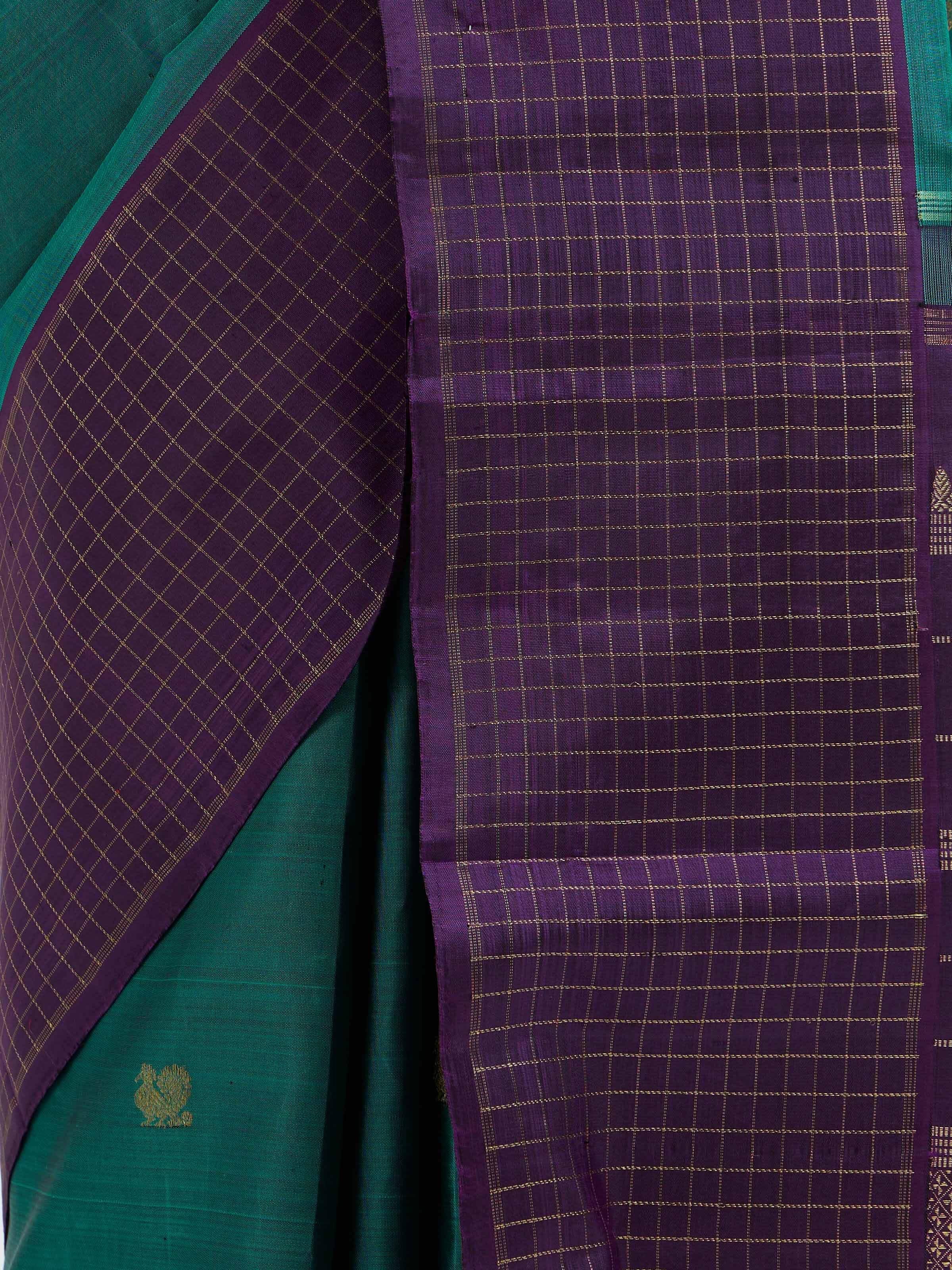 Detail view of green silk Kancheepuram saree showing zari craftsmanship