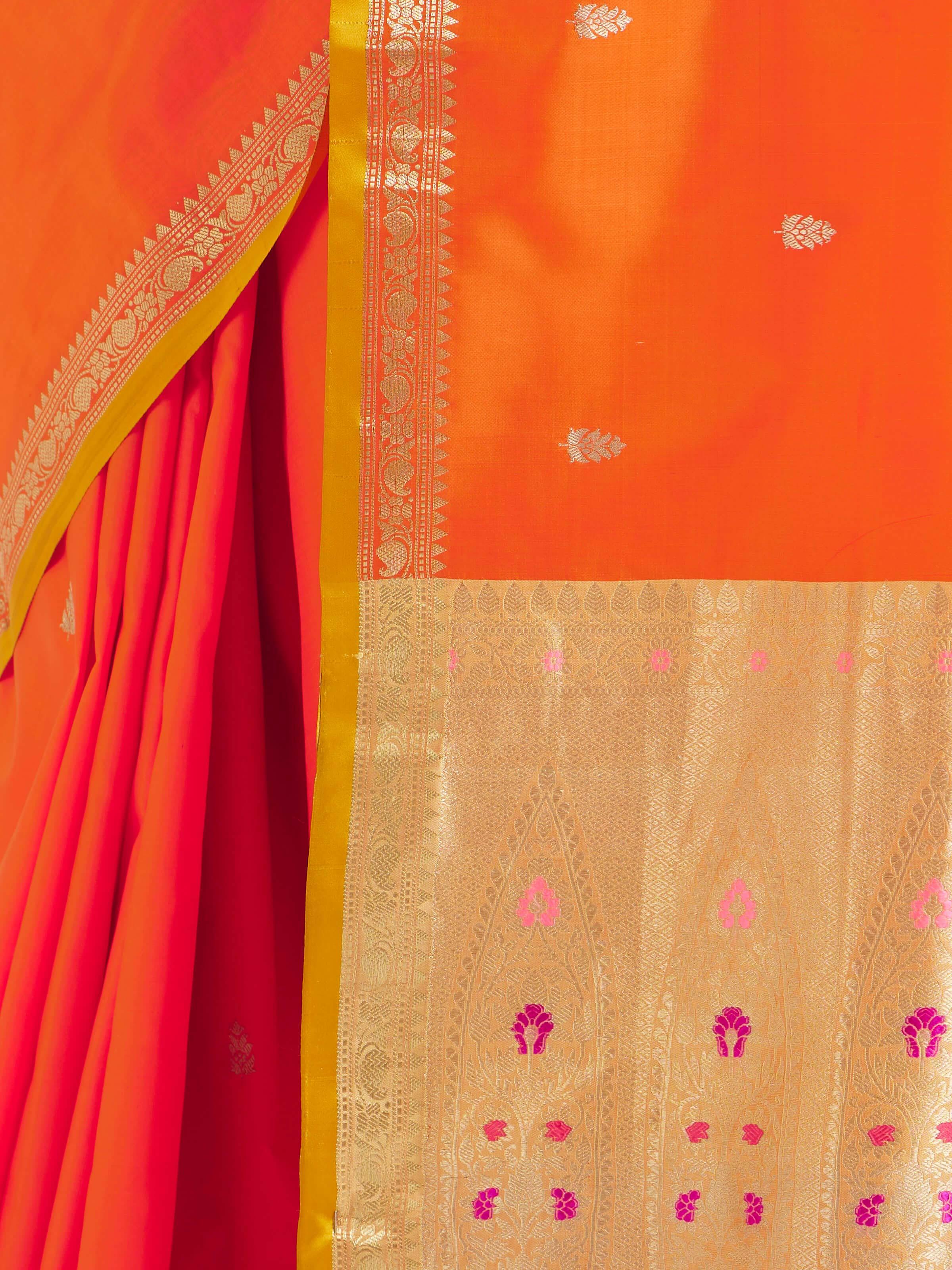 Detail view of orange mulberry katan silk Banarasi saree highlighting silk texture and weave