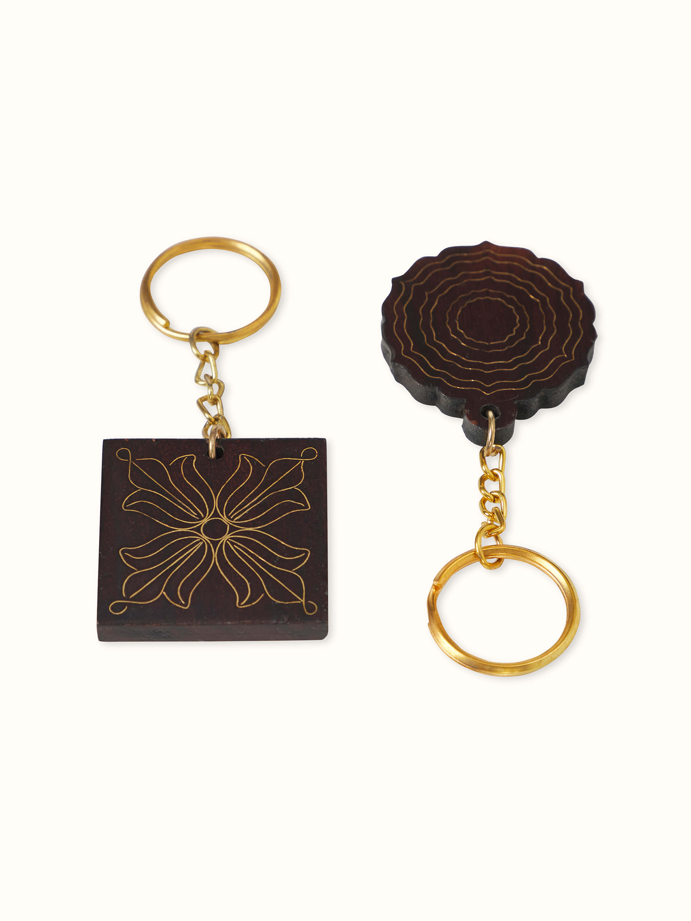 Front view of Tarkashi Sheesham wood & brass keychains set showcasing intricate brass detailing