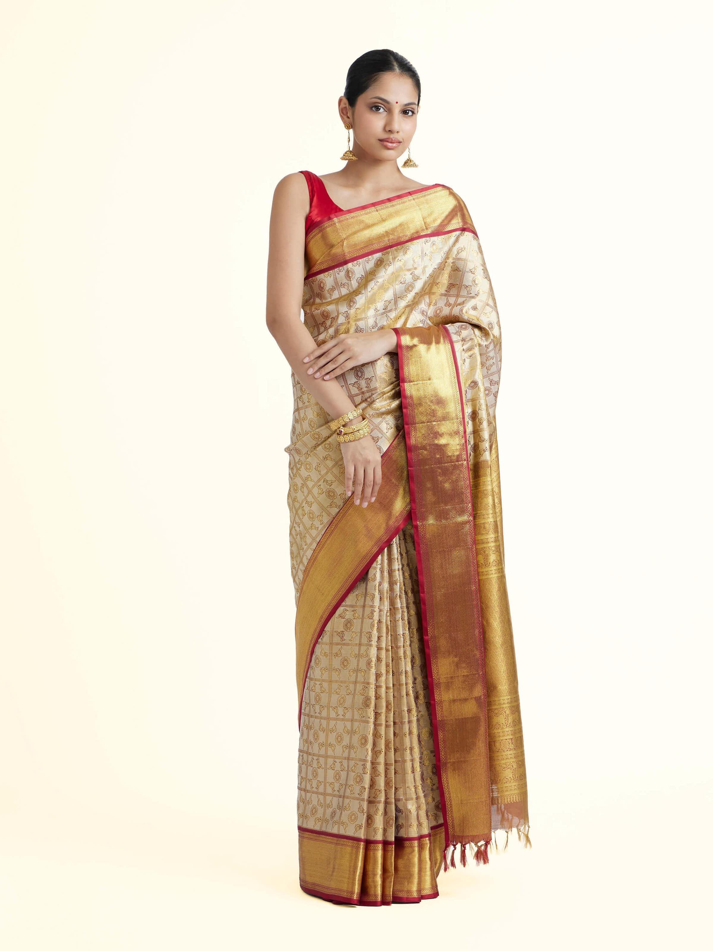 Front view of gold silk Kancheepuram saree with rich zari woven motifs