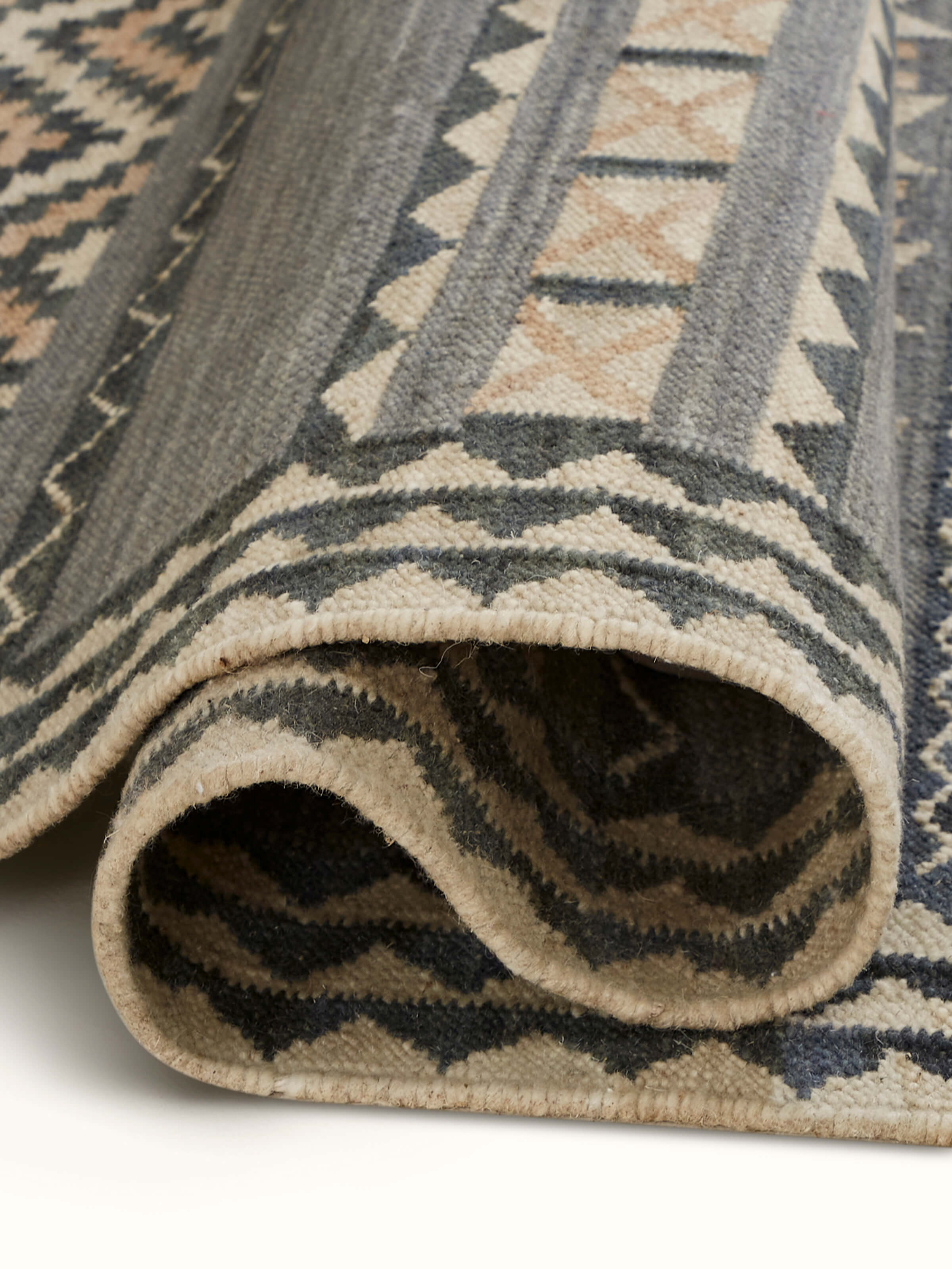 Detailed shot showing the fine finishing and edges of the dhurrie