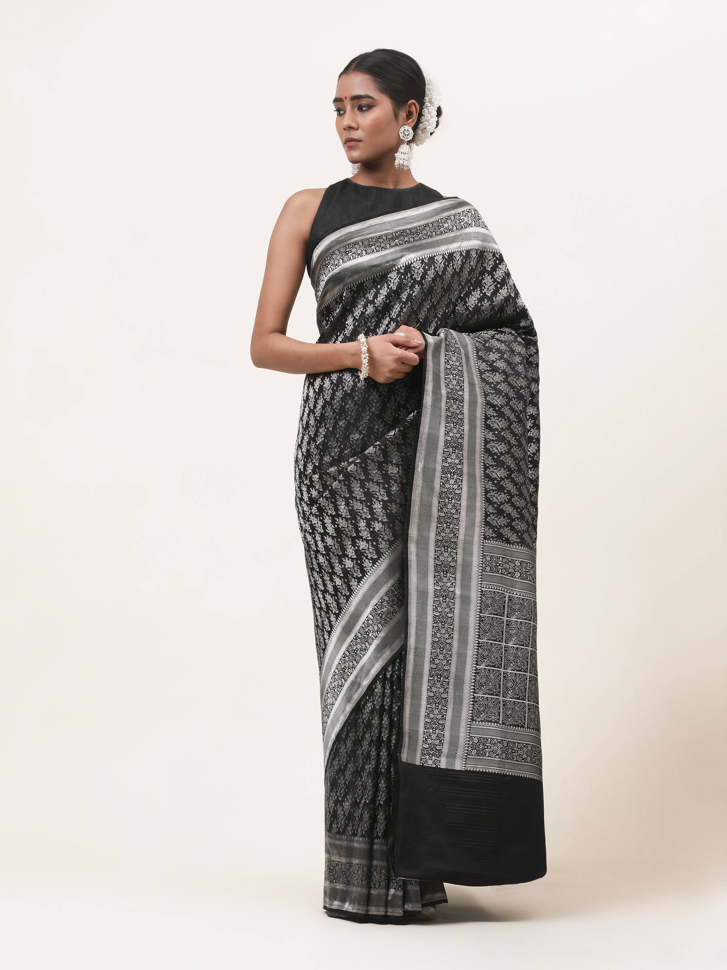 Front view of Black Silk Satin Tanchoi Banarasi Saree featuring glossy satin finish and traditional motifs.