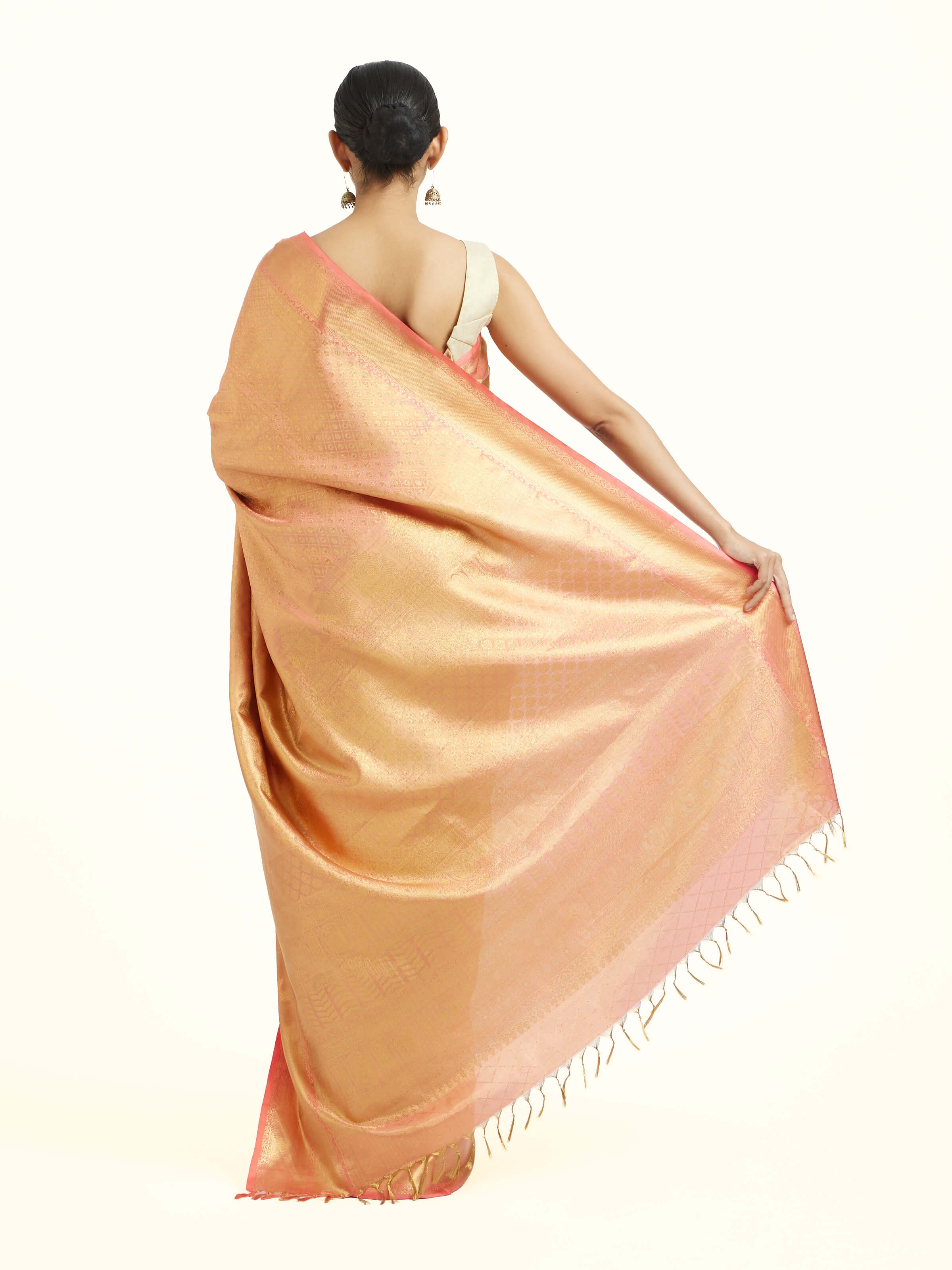 Back view of peach silk Kancheepuram saree displaying grand pallu