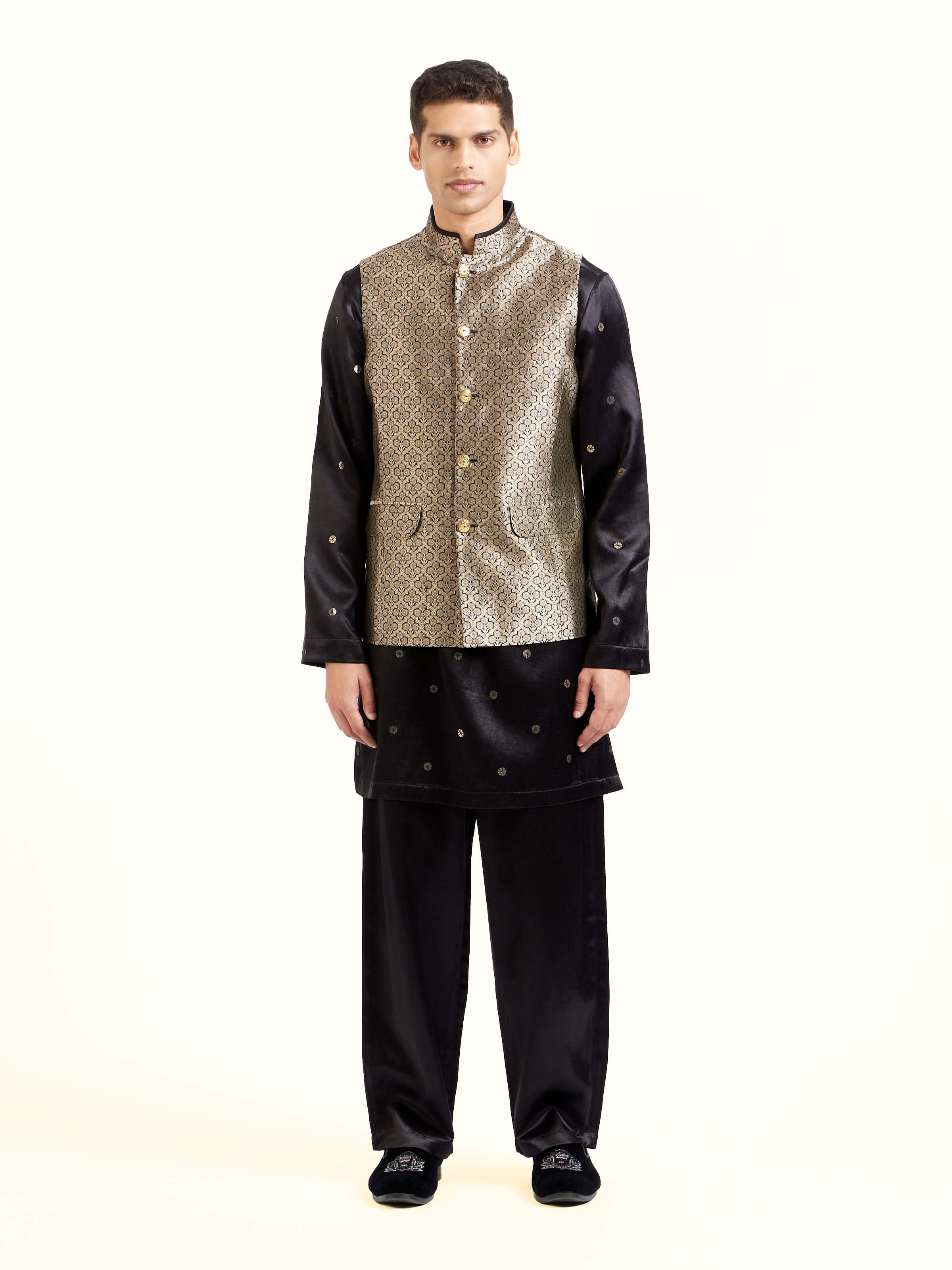 Front view of black silk Banarasi sleeveless jacket with brocade detailing
