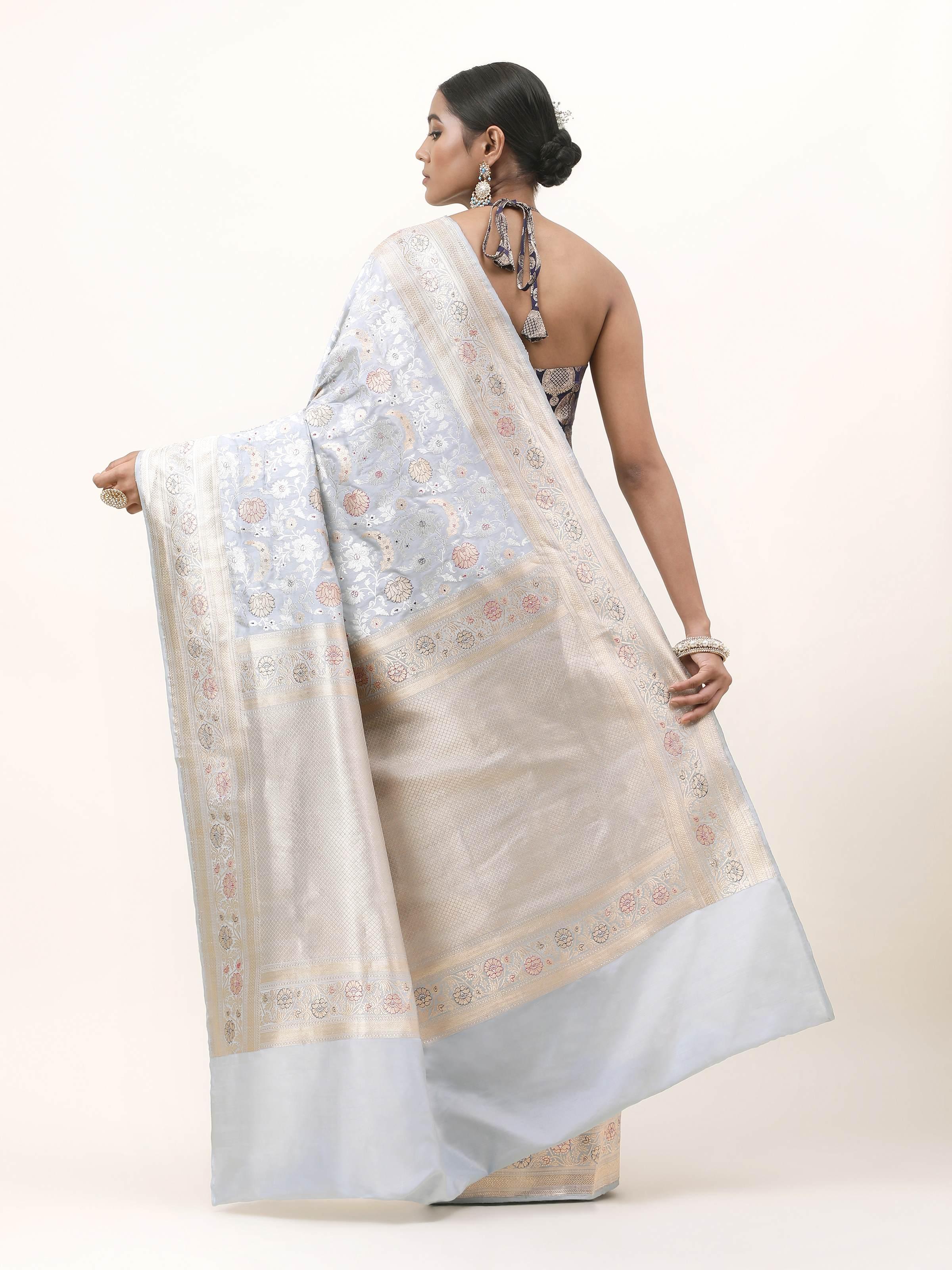 Back view of ice blue Katan silk Banarasi saree showing pleats and border fall.