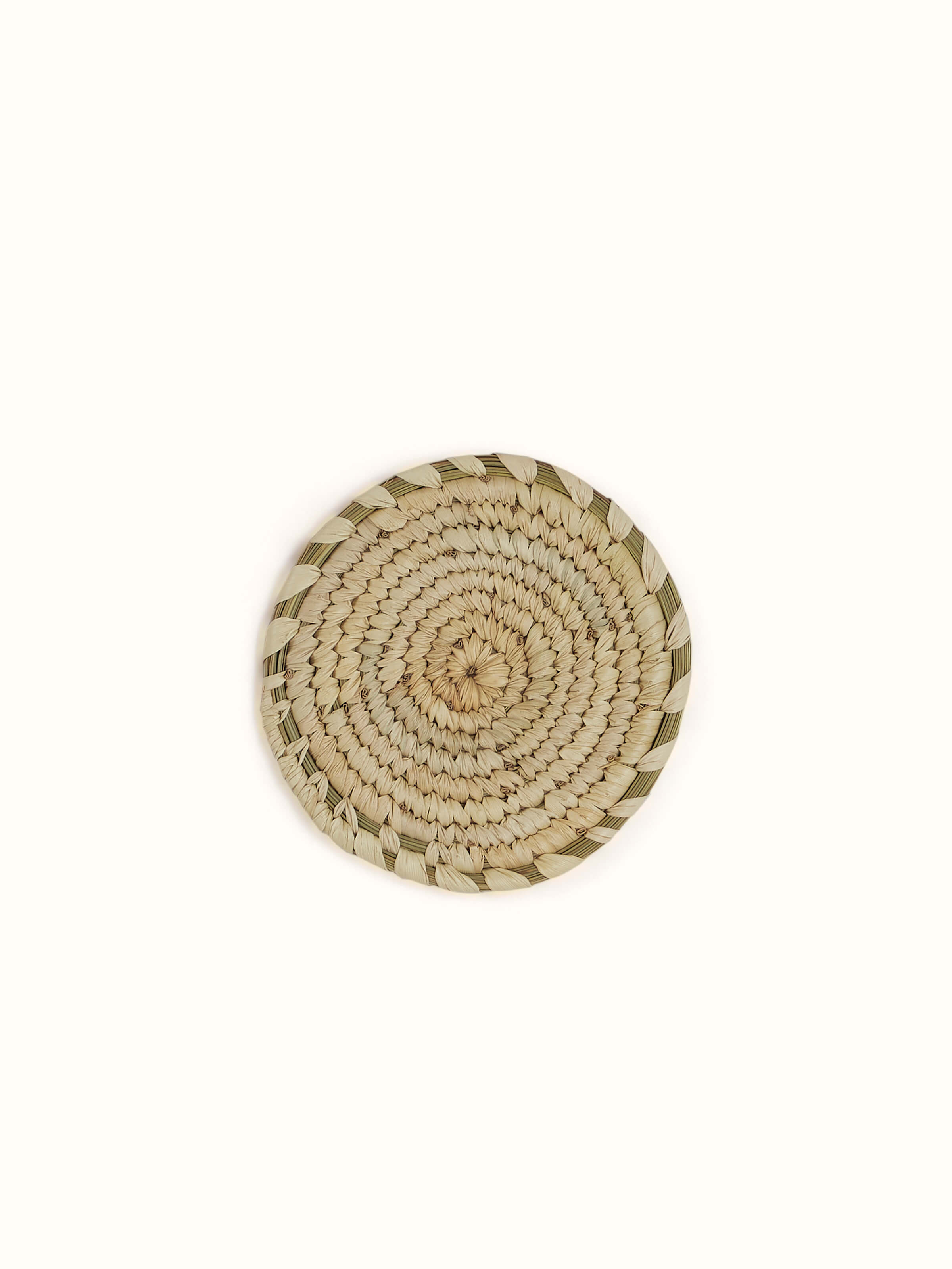 Front view of Amodini light green Sabai grass coasters set of 6 stacked neatly to show size and round shape.