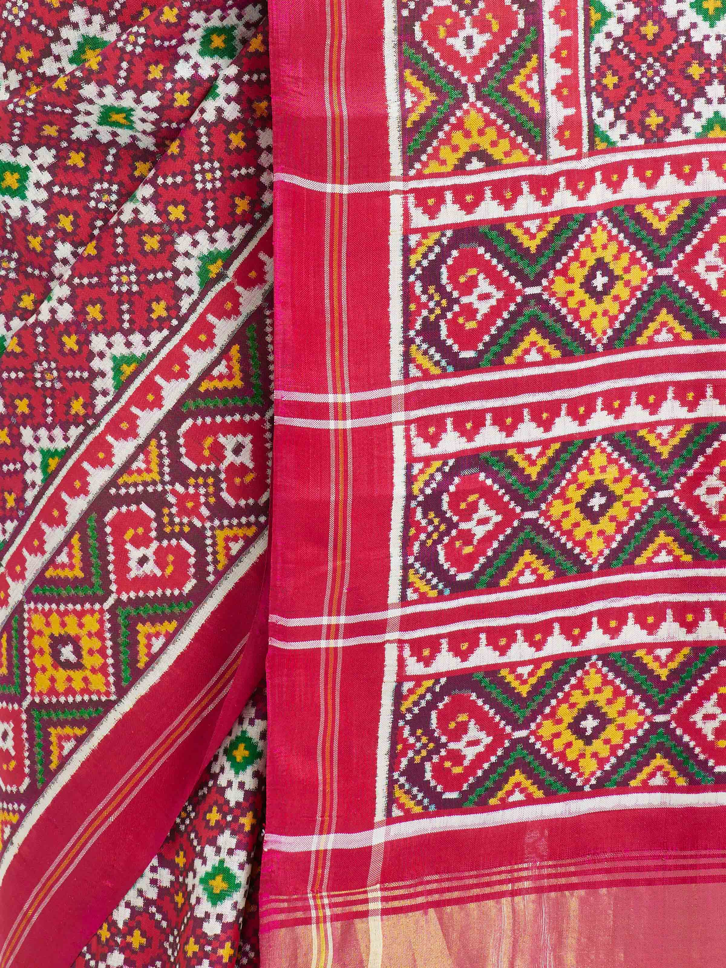 Detail view of pink mulberry silk Patan Patola saree showing fabric texture and weave