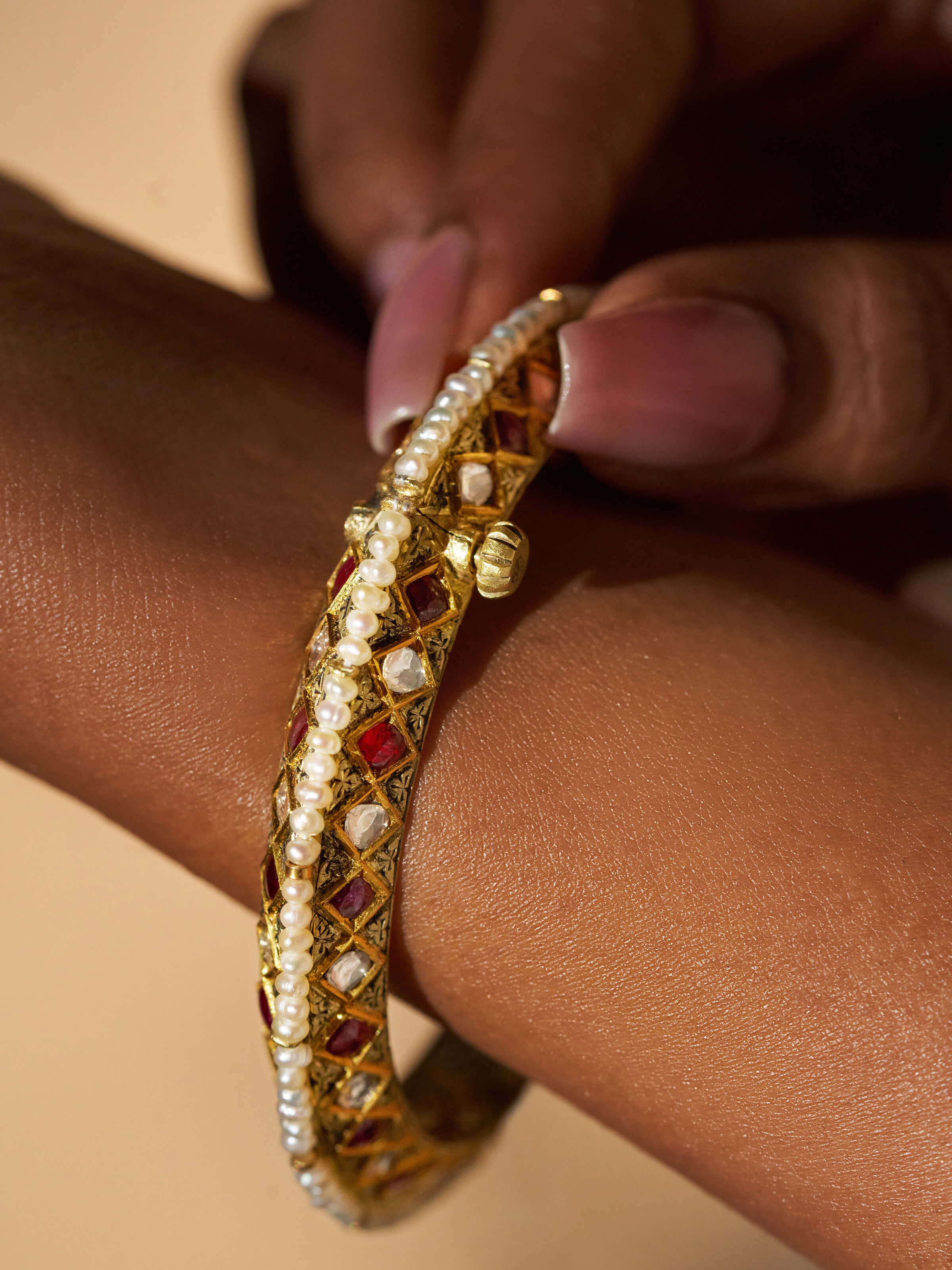 Side view of 18 karat gold bangle emphasizing smooth finish and gold quality