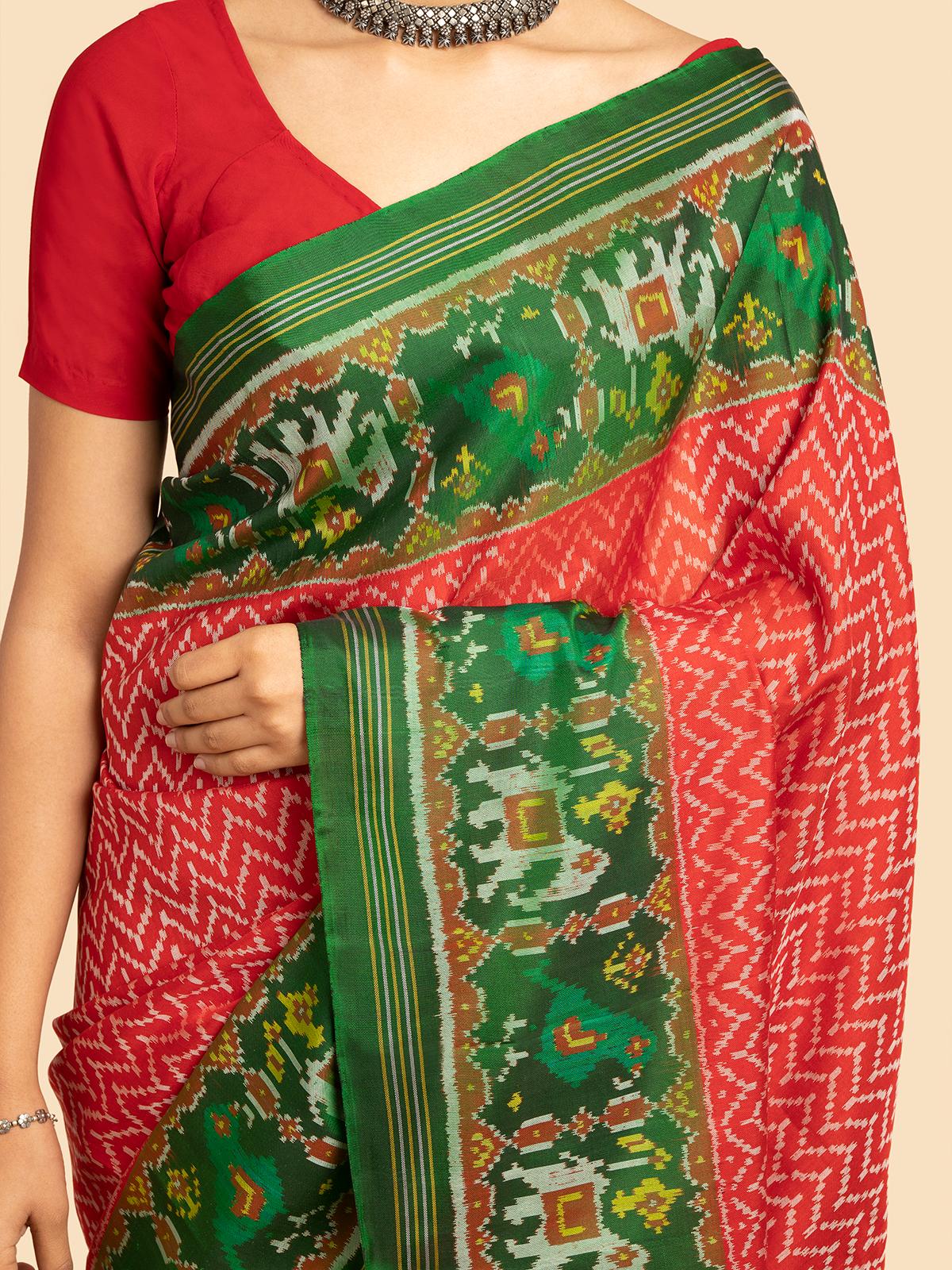 Detailed view of red silk patola saree’s border and draping style
