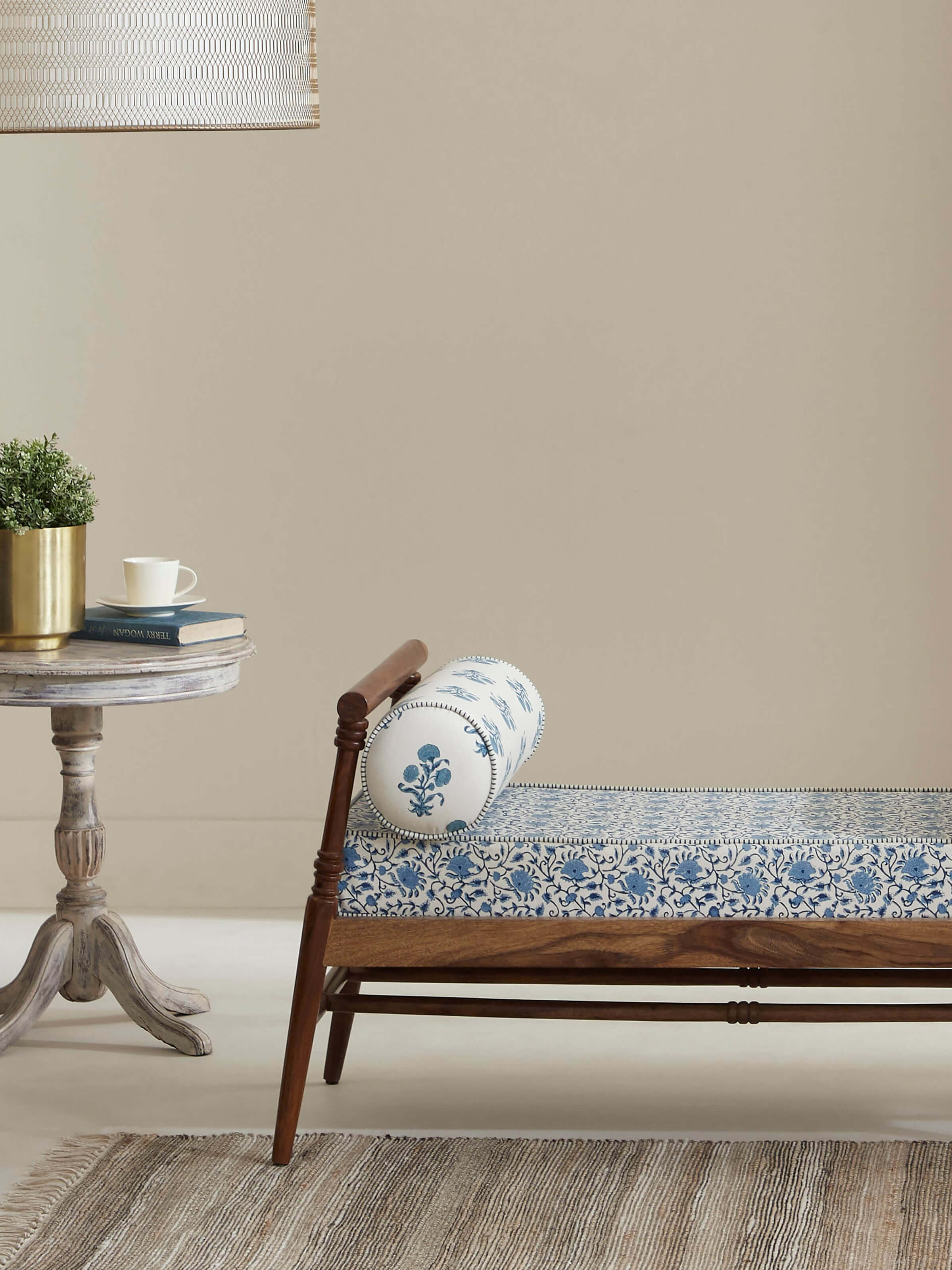 Side view of the Sheesham wood bench highlighting the slanted legs and block print design